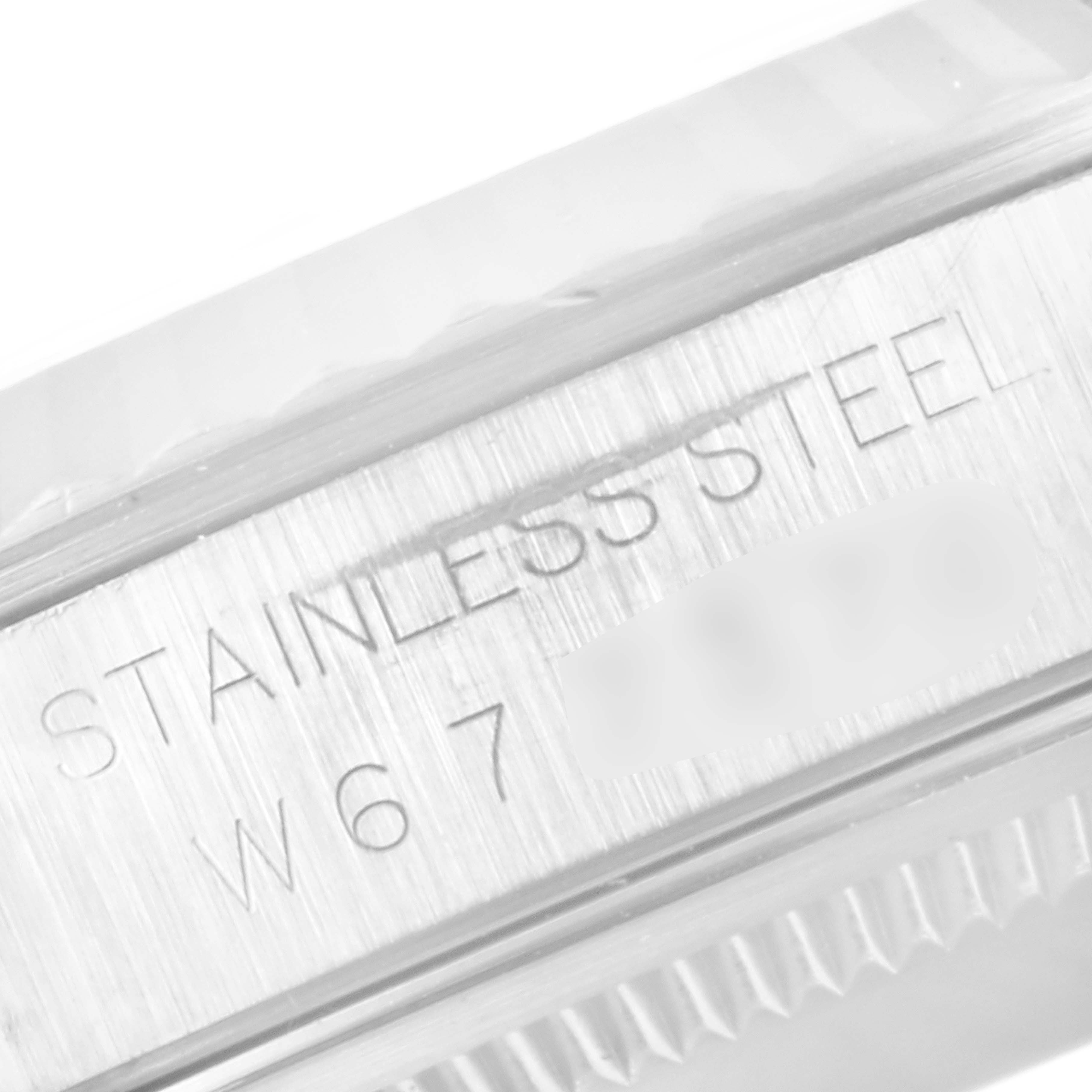 The image shows a close-up of the stainless steel case and serial number on a Rolex Datejust 16234 Men's Stainless Steel White Dial 16234 Men's Stainless Steel White Dial model watch.