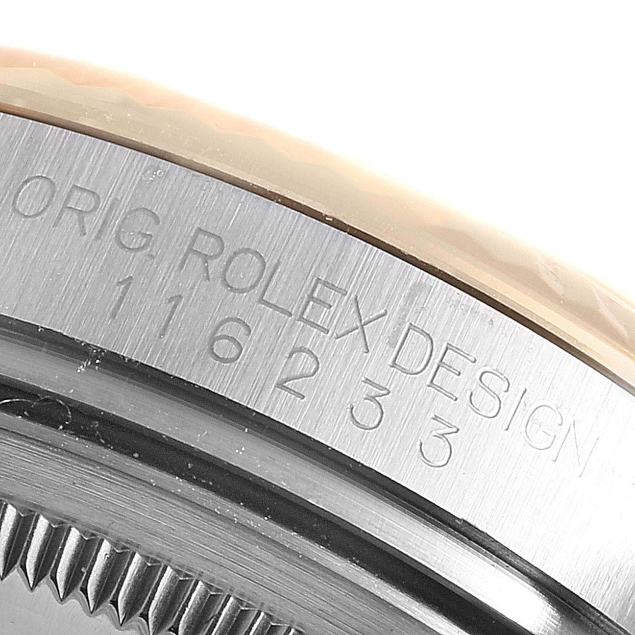 This close-up image shows the engraved model number on the case side of a Rolex Datejust 116233 Men
s Steel and Gold (two tone) Black Dial 116233 Men
s Steel and Gold (two tone) Black Dial watch.