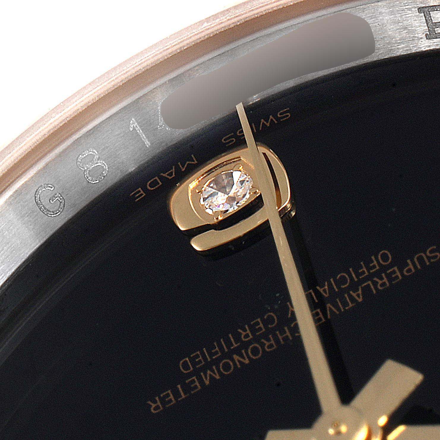 Close-up of the Rolex Datejust 116233 Men
s Steel and Gold (two tone) Black Dial 116233 Men
s Steel and Gold (two tone) Black Dial watch showing a portion of the dial, gold accents, and part of the bezel.