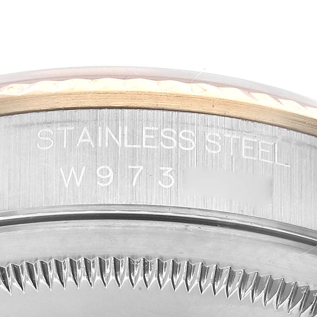 This image shows a close-up of the stainless steel bezel and part of the engraved serial number of a Rolex Datejust 16233 Men's Steel and Gold (two tone) Champagne Dial 16233 Men's Steel and Gold (two tone) Champagne Dial watch.