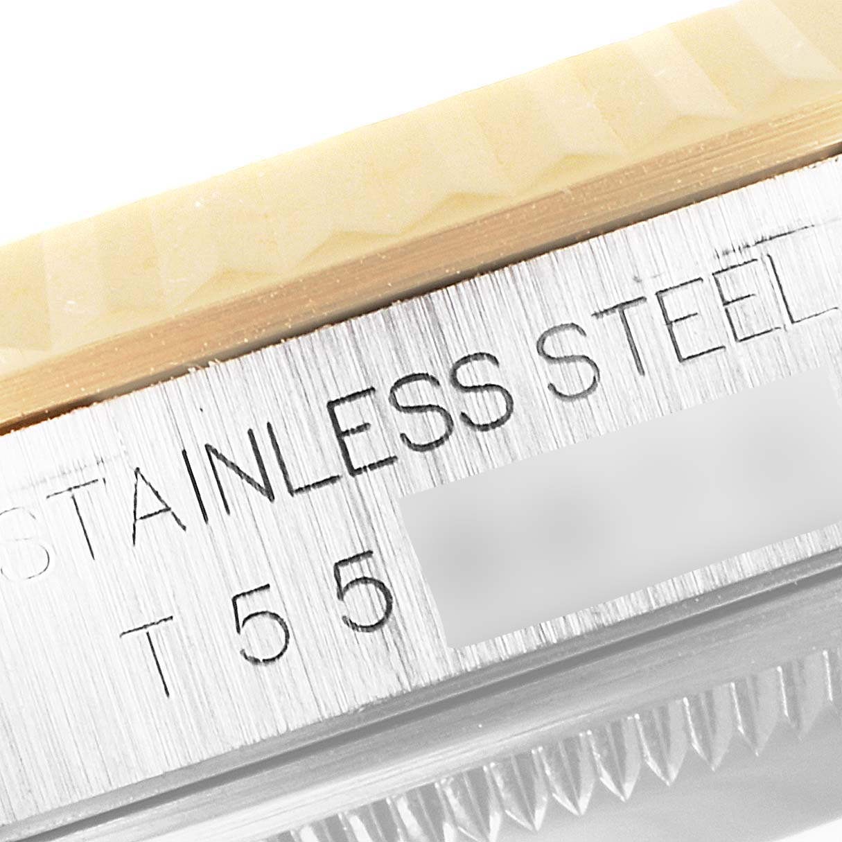 This close-up image shows the side view of the bezel and case of the Rolex Datejust 16233 Men's Steel and Gold (two tone) White Dial 16233 Men's Steel and Gold (two tone) White Dial watch, highlighting "STAINLESS STEEL" engraving.