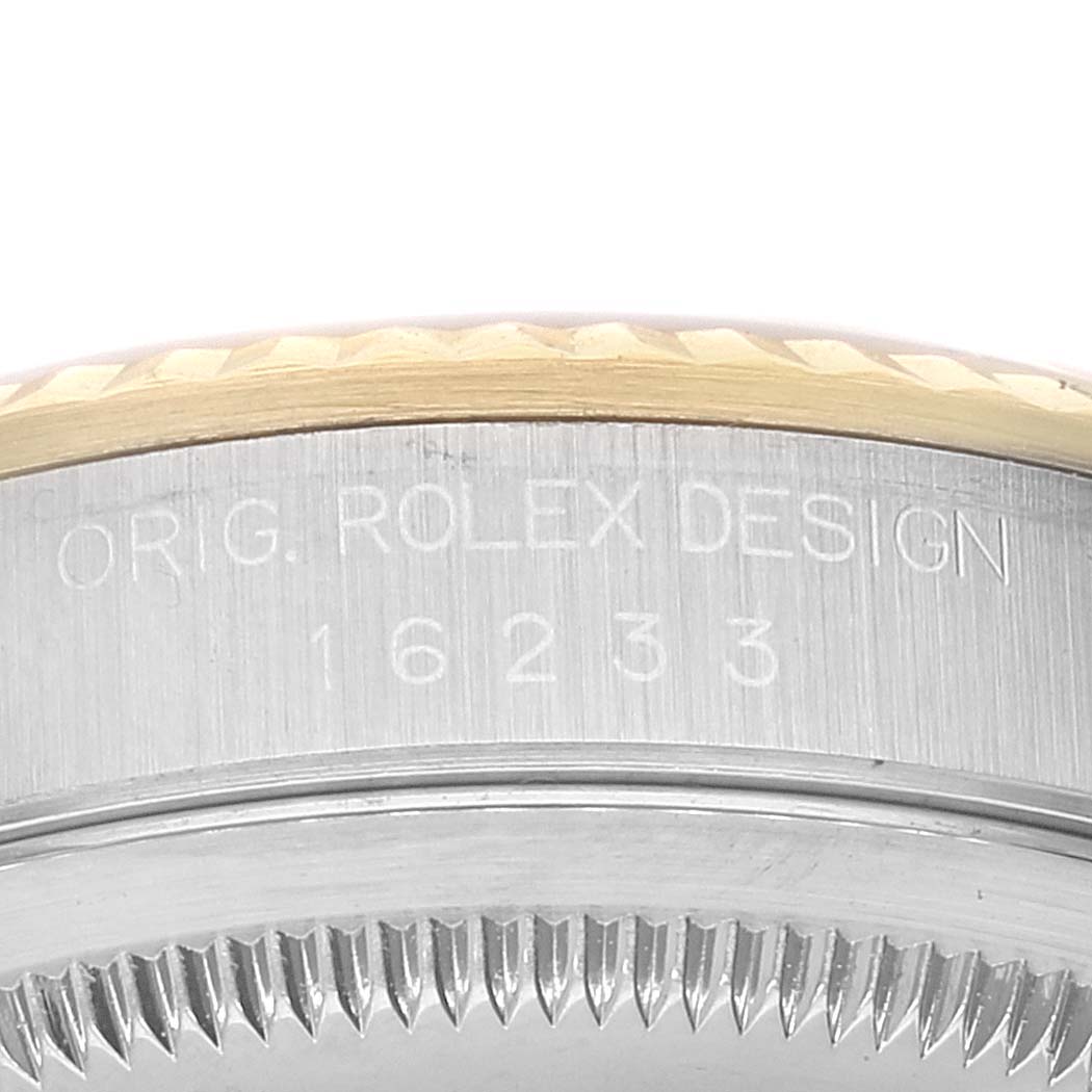 This image shows a close-up of the side of a Rolex Datejust 16233 Men's Steel and Gold (two tone) White Dial 16233 Men's Steel and Gold (two tone) White Dial watch, displaying its model number 16233 and fluted bezel.