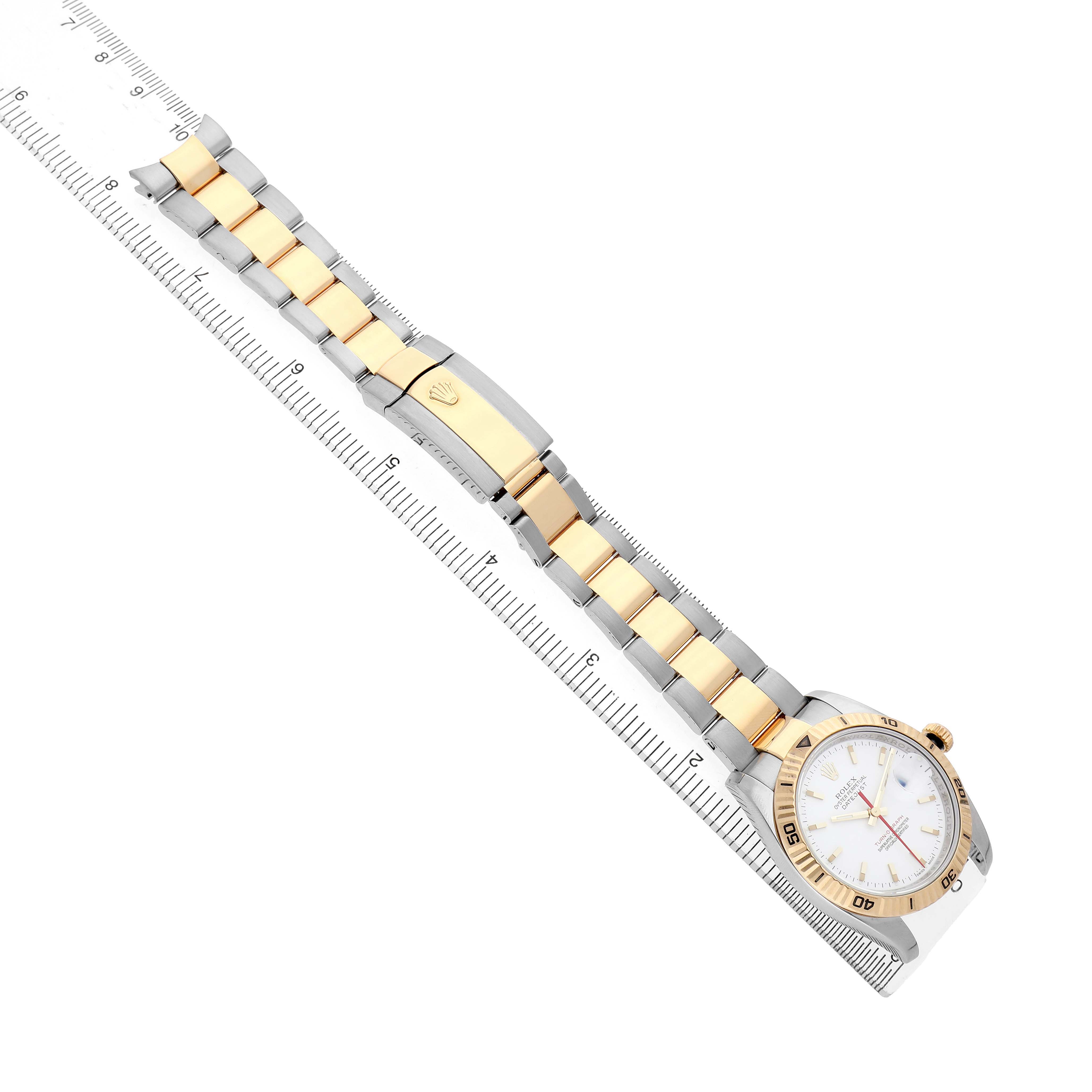 The Rolex Datejust 116263 Men's Stainless Steel White Dial is shown at an elevated angle, displaying its full band and face next to a ruler for scale.