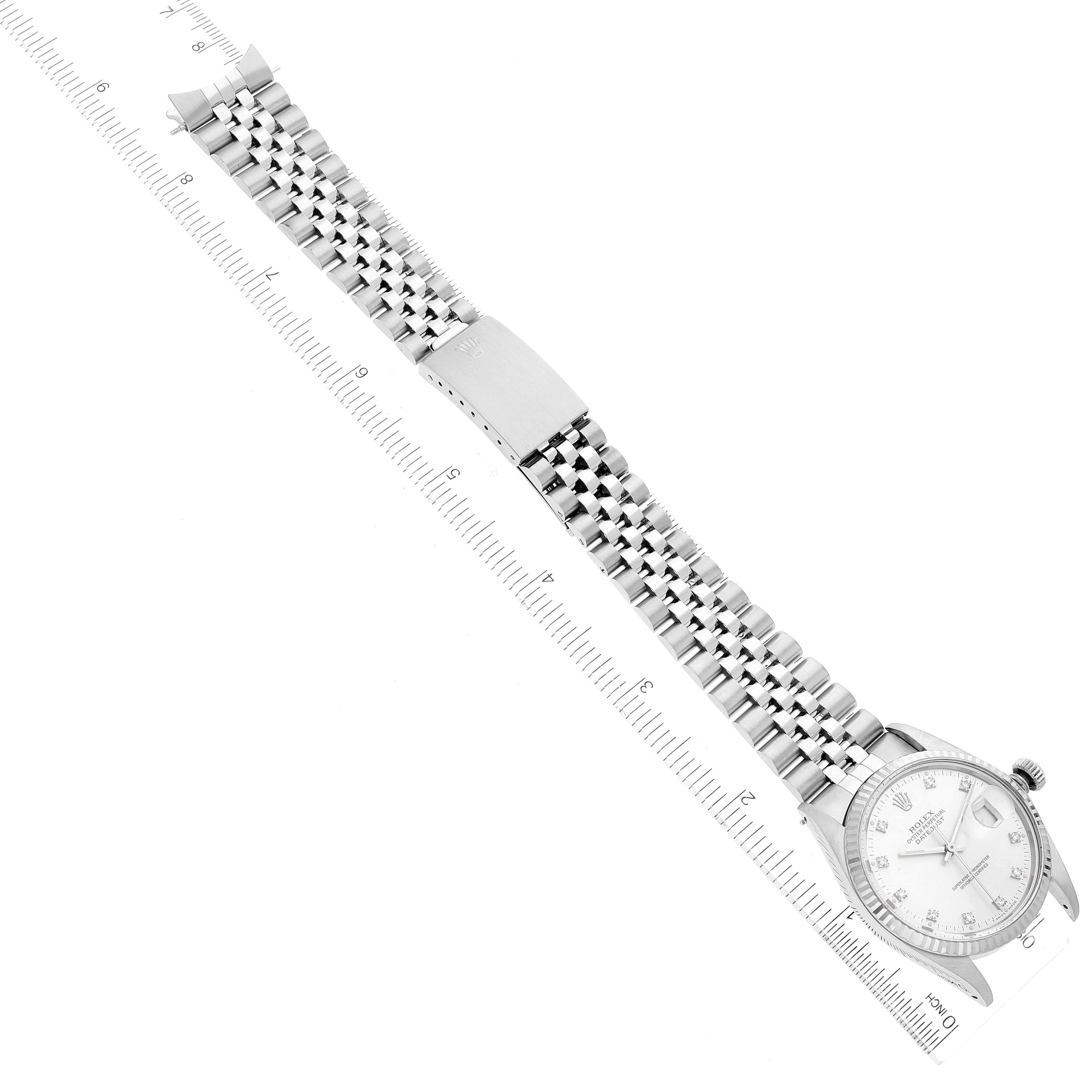 The image shows a top-down view of the Rolex Vintage Collection 16014 Men
s Stainless Steel Silver Dial 16014 Men
s Stainless Steel Silver Dial watch, highlighting its face and metal bracelet with a ruler for scale.