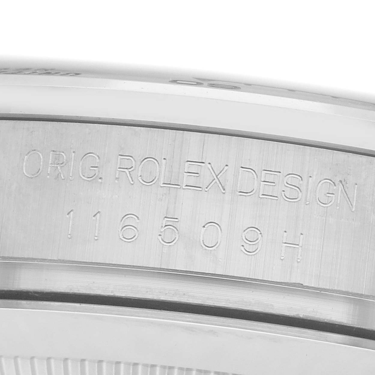 The image shows a detailed close-up of the side of the Rolex Daytona 116509 Men
s White Gold Black Dial case with the engraving "ORIG. ROLEX DESIGN 116509H".