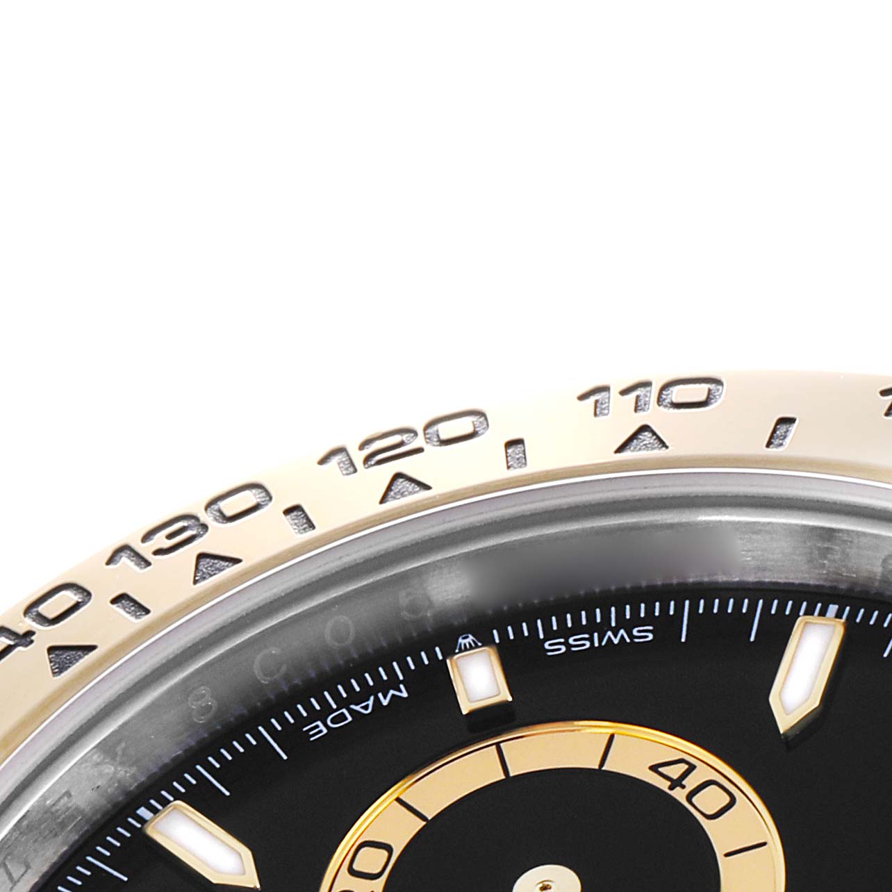 The image shows a close-up of the bezel and part of the dial of a Rolex Daytona 126503 Men
s Steel and Gold (two tone) Black Dial, highlighting the tachymetric scale and subdial.