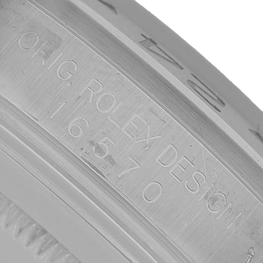 The image shows a close-up of the engraved bezel side on a Rolex Explorer 16570 Men's Stainless Steel Black Dial, highlighting the markings.