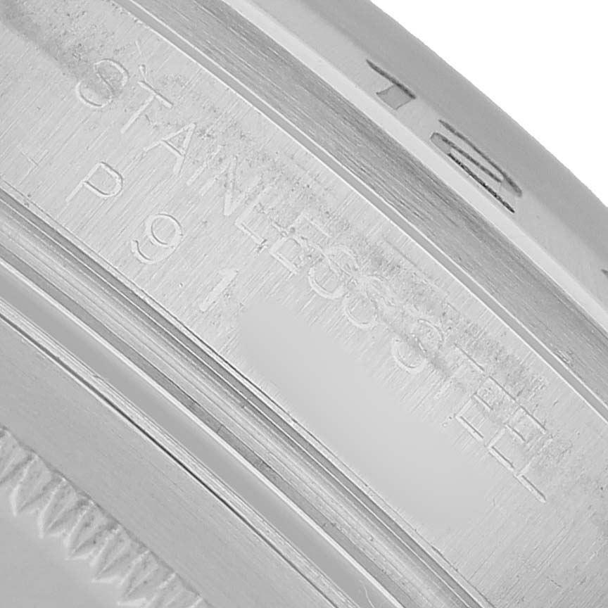 The image shows a close-up of the side of a Rolex Explorer 16570 Men's Stainless Steel Black Dial, detailing engravings on the stainless steel surface.