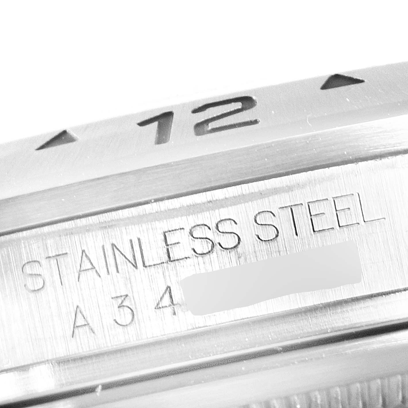 The image shows a close-up of the bezel and the stainless steel marking on the Rolex Explorer 16570 Men
s Stainless Steel White Dial 16570 Men
s Stainless Steel White Dial watch.