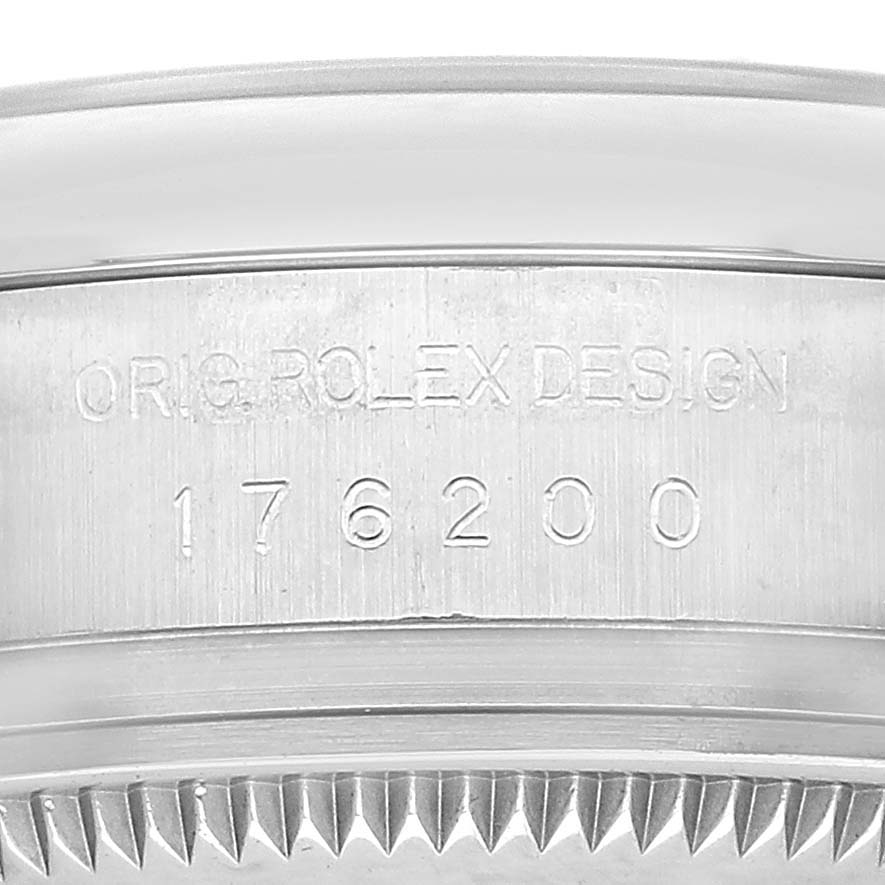 This image shows a close-up of the side of the Rolex Oyster Perpetual 176200 Women's Stainless Steel Black Dial watch, highlighting the model number and "ORIG ROLEX DESIGN" engraving.