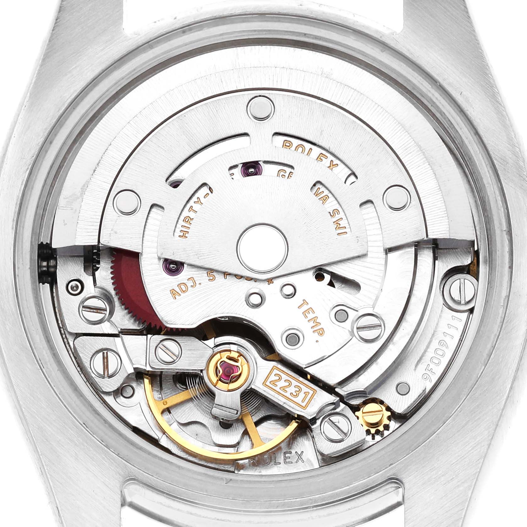 The image shows the movement of a Rolex Oyster Perpetual 176200 Men's Stainless Steel Black Dial watch from a rear case view, highlighting the intricate mechanical parts.