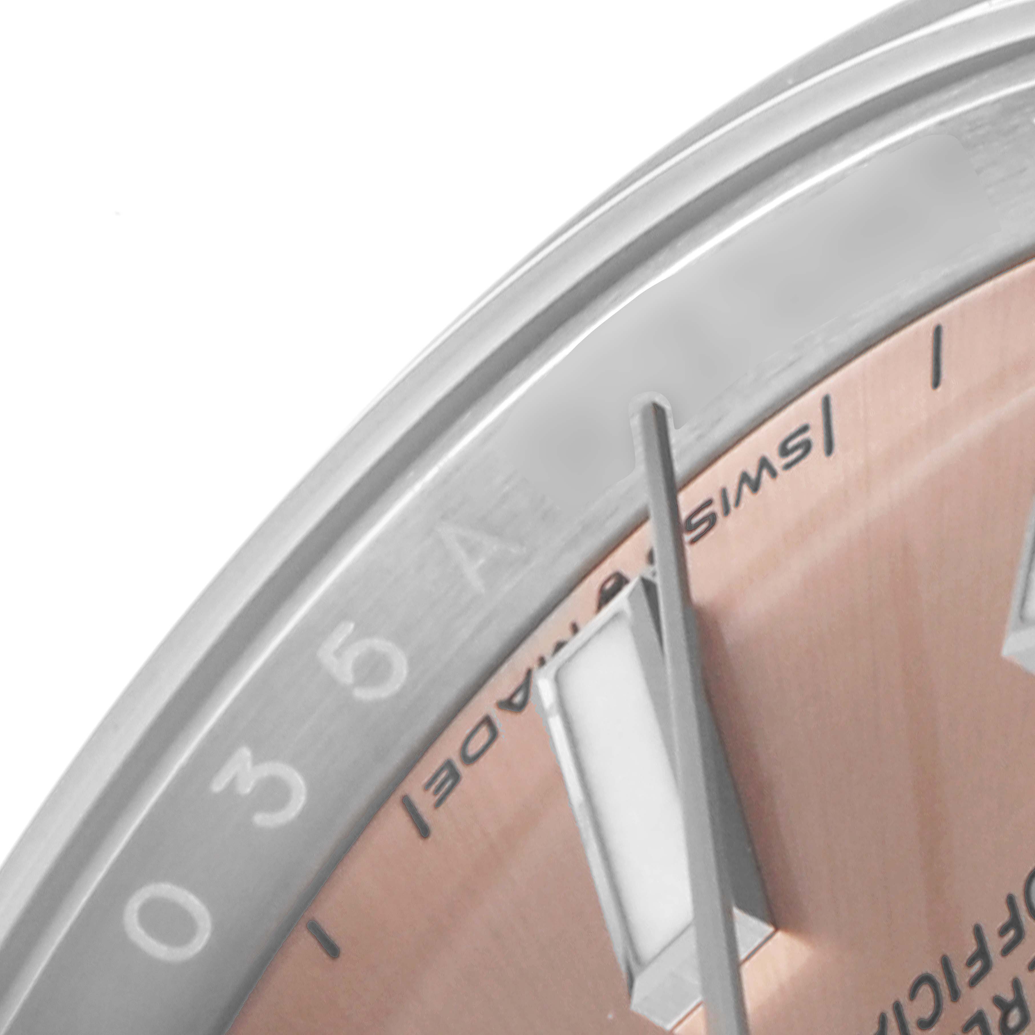 The image shows a close-up of the dial and bezel of a Rolex Oyster Perpetual 124200 Men
s Stainless Steel Pink Dial 124200 Men
s Stainless Steel Pink Dial watch, highlighting the “Swiss Made” text and hour markers.