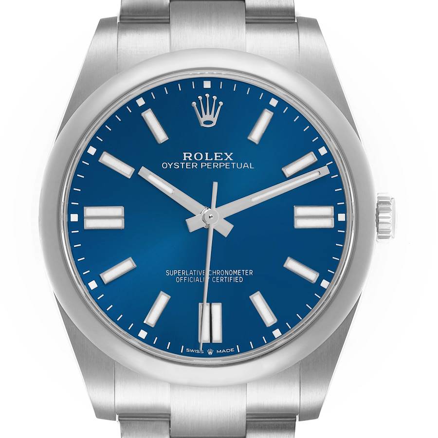The Rolex Oyster Perpetual model 124300 is shown from the front, highlighting its blue dial, hands, indices, crown, and portion of the stainless steel bracelet.