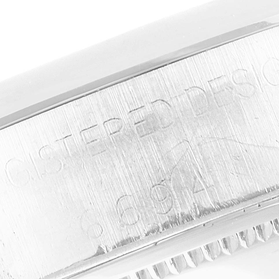 This image shows a close-up of the engraved side of the case of a Vintage Collection model by Rolex.