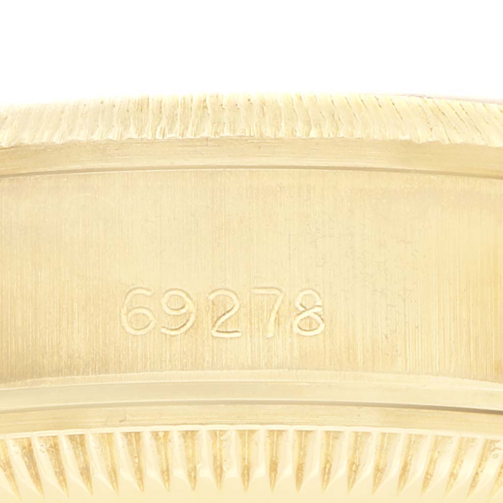 The image shows a close-up of the side of a Rolex President 69278 Women
s Yellow Gold Champagne Dial model, highlighting the serial number on the case.