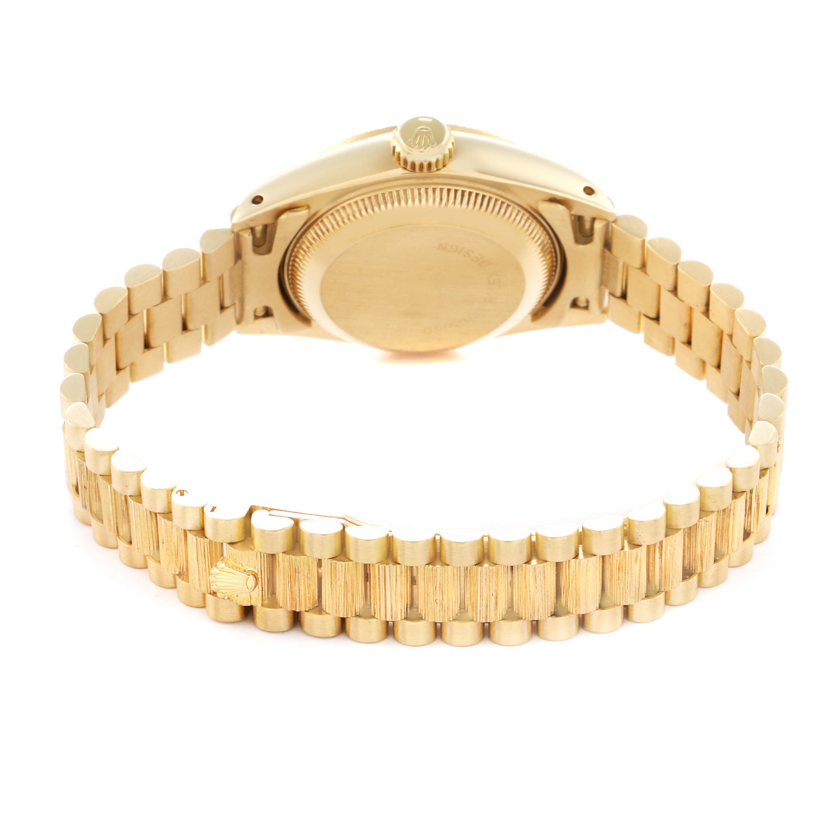 The image shows the back of the Rolex President 69278 Women
s Yellow Gold Champagne Dial watch, highlighting its bracelet and clasp from a high-angle view.