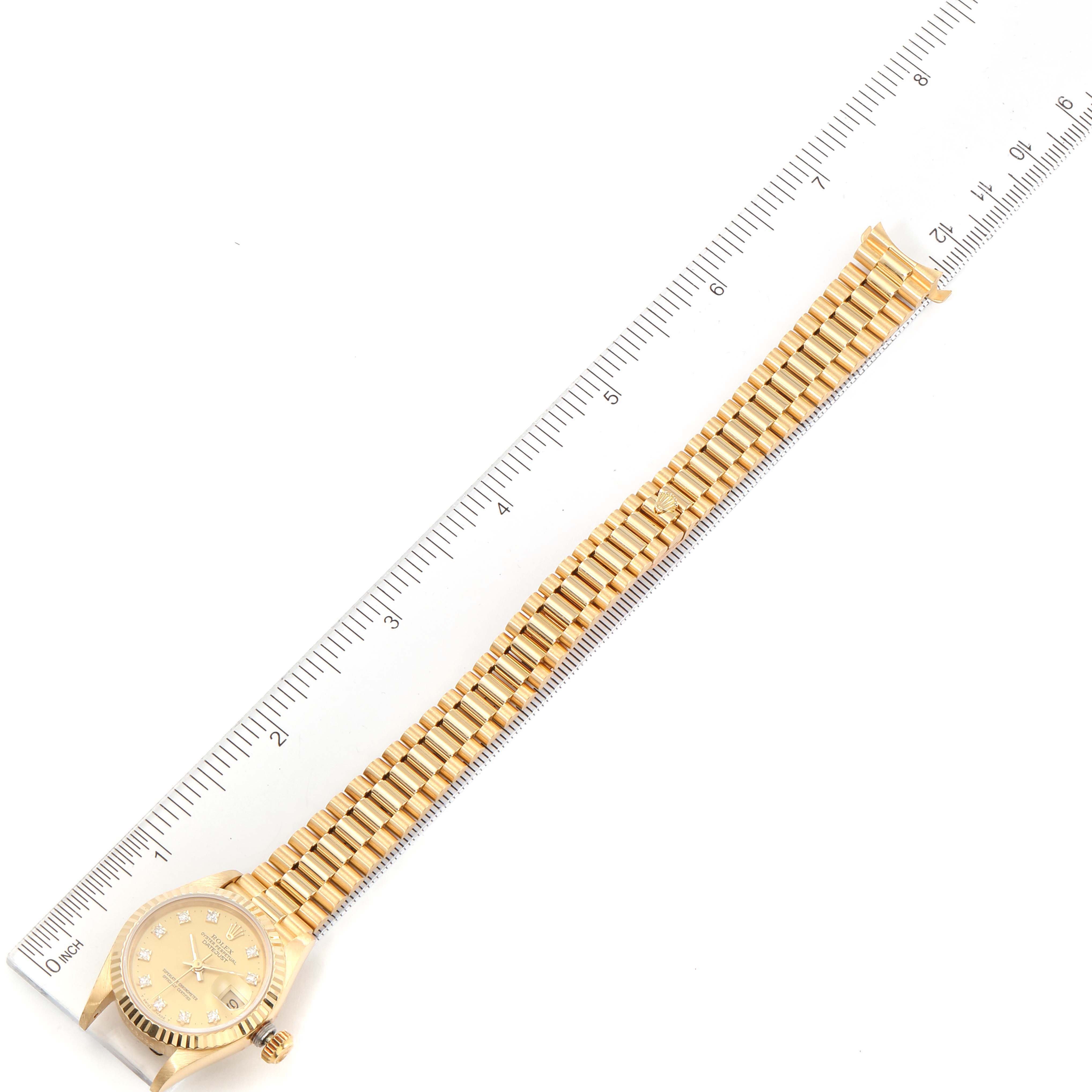 The image shows a top-down view of a Rolex President 69178 Women
s Yellow Gold Champagne Dial 69178 Women
s Yellow Gold Champagne Dial model watch, laid beside a ruler for measurement.