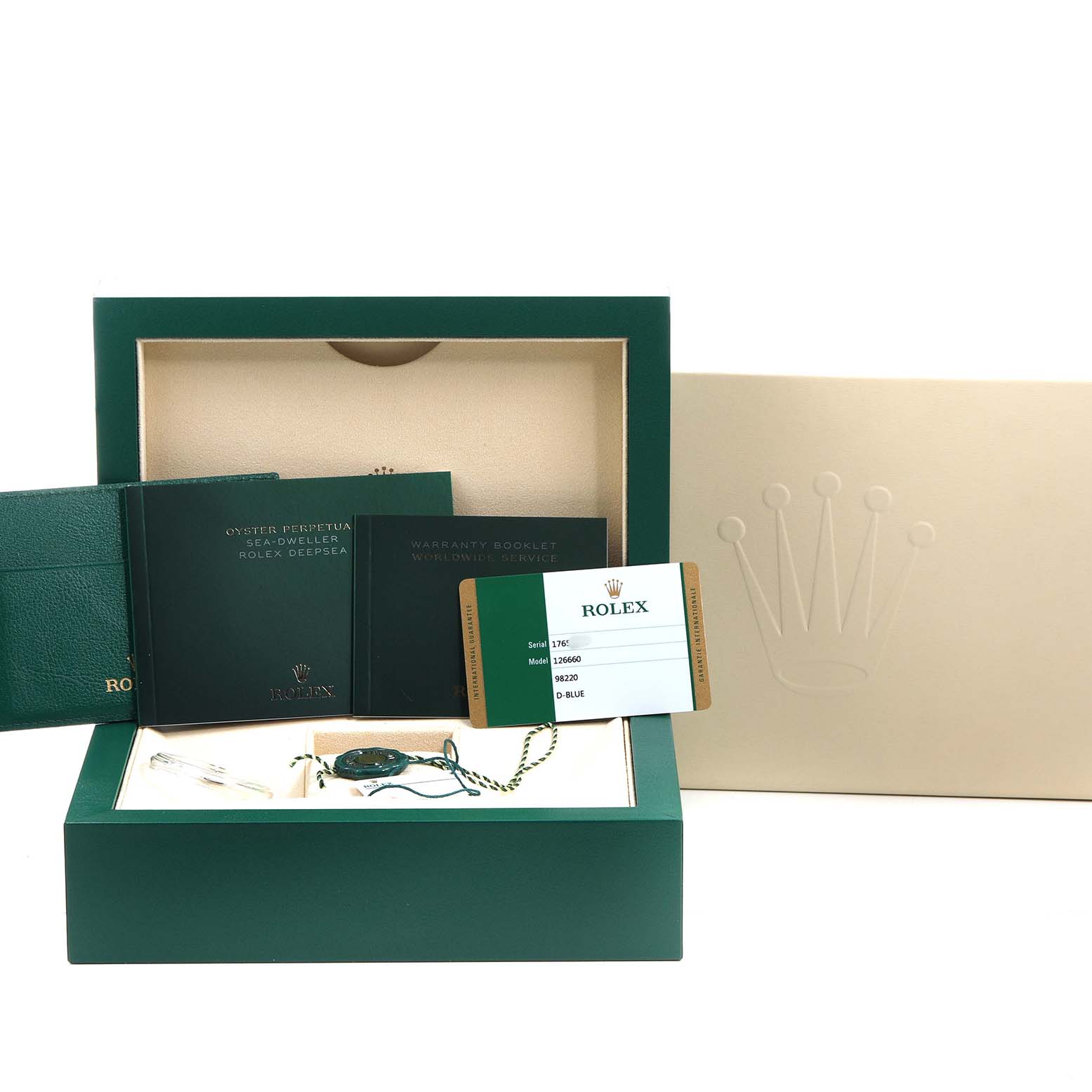 The image shows the packaging and accessories for a Rolex Sea-Dweller 126660 Men's Stainless Steel Blue Dial, including the box, booklets, card, and tag from a frontal angle.