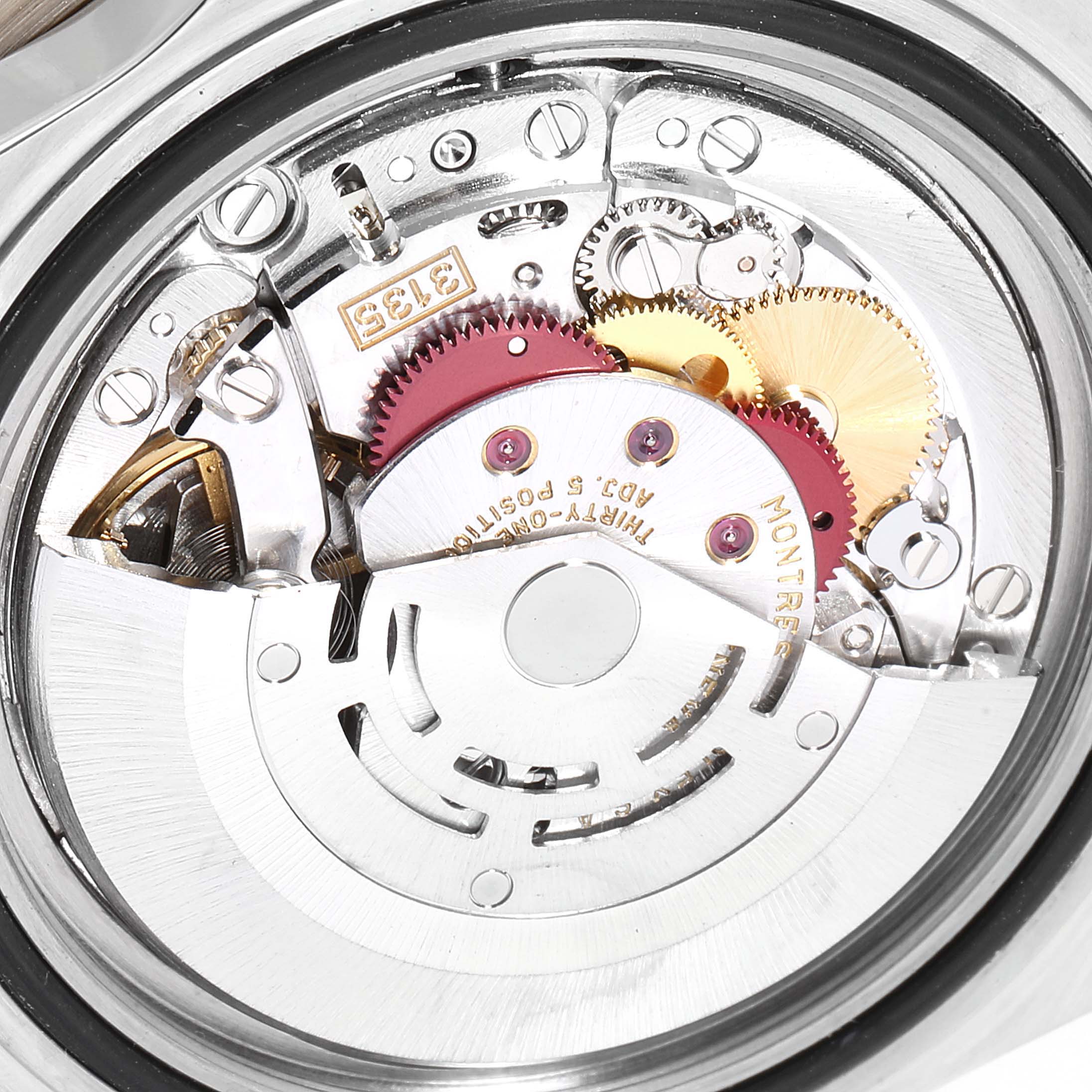 The image shows an inside view of the movement mechanism of a Rolex Submariner 16613 Men
s Steel and Gold (two tone) Black Dial 16613 Men
s Steel and Gold (two tone) Black Dial watch, revealing gears and mechanical components.