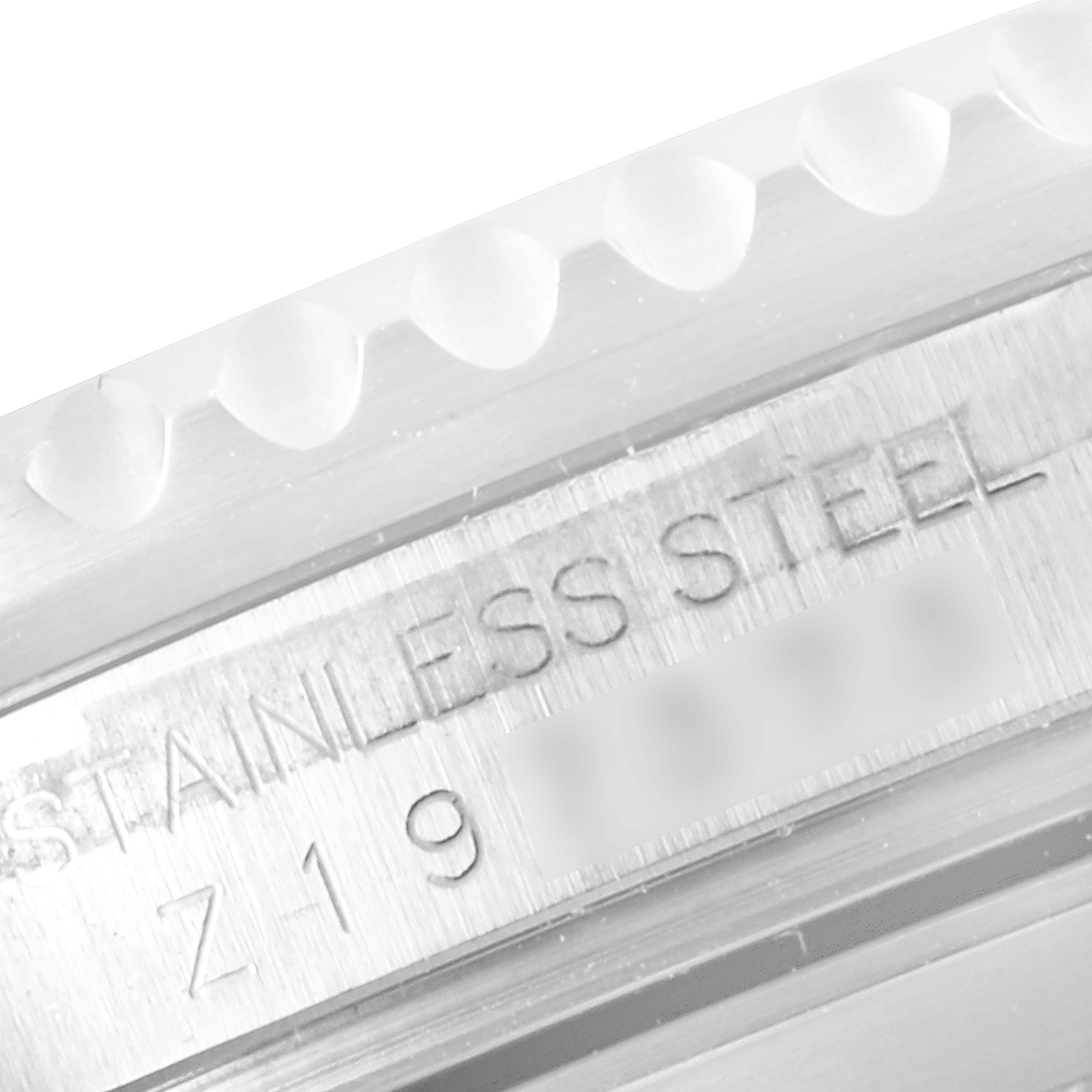 This close-up image of a Rolex Submariner 16610 Men
s Stainless Steel Black Dial 16610 Men
s Stainless Steel Black Dial watch shows a portion of the stainless steel case and engravings.