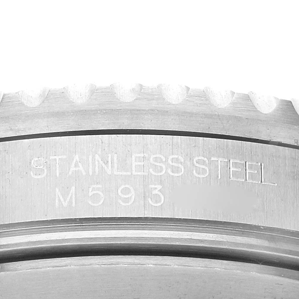 This image shows a close-up of the stainless steel case back flange and part of the bezel on a Rolex Submariner 16610 Men
s Stainless Steel Black Dial 16610 Men
s Stainless Steel Black Dial watch.