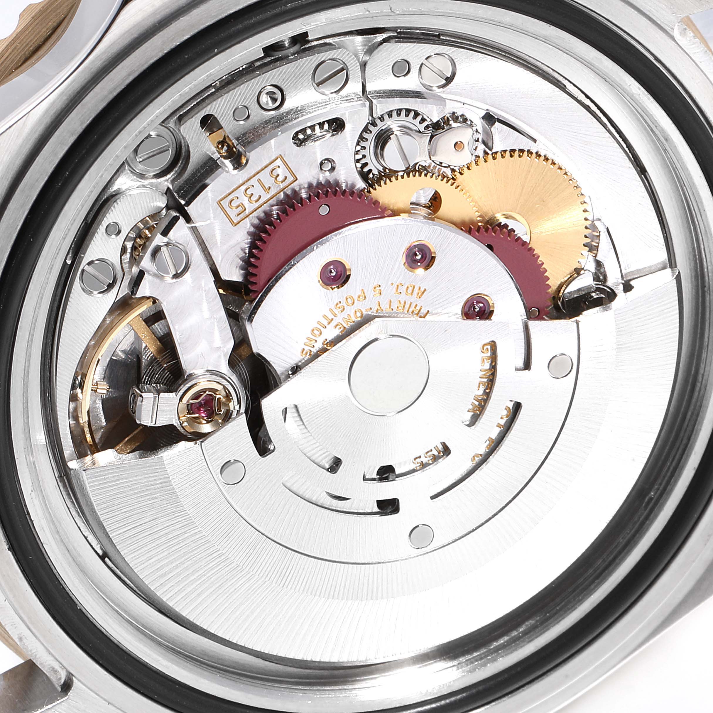 This image shows the intricate internal mechanism of a Rolex Submariner 16613 Men
s Steel and Gold (two tone) Grey Dial 16613 Men
s Steel and Gold (two tone) Grey Dial watch from a close-up angle.