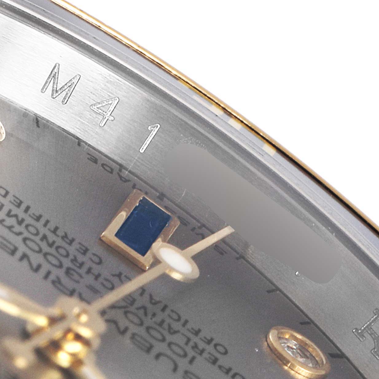The image shows a close-up of the dial and inner bezel of a Rolex Submariner 16613 Men
s Steel and Gold (two tone) Grey Dial 16613 Men
s Steel and Gold (two tone) Grey Dial, with focus on the inscriptions.