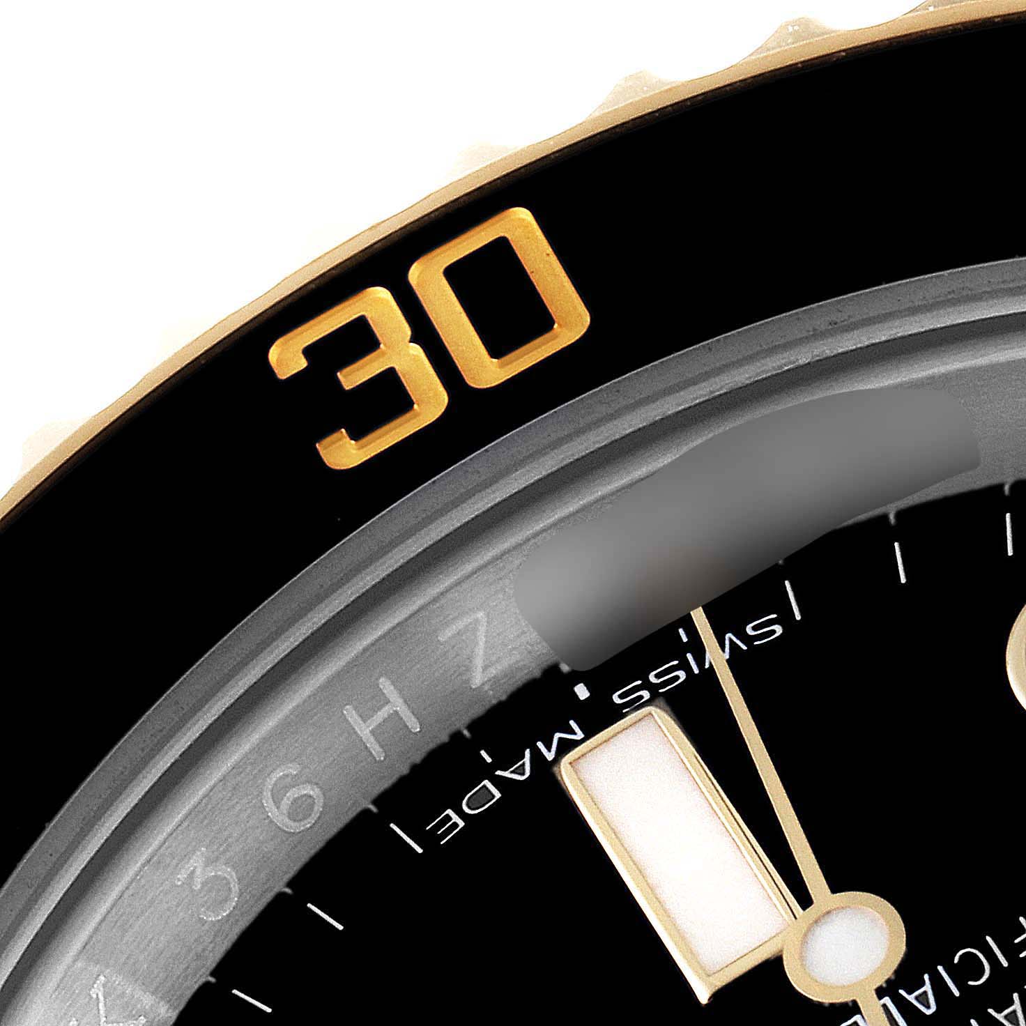 The image shows a close-up of the bezel and dial of a Rolex Submariner 116613 Men
s Steel and Gold (two tone) Black Dial 116613 Men
s Steel and Gold (two tone) Black Dial watch, focusing on the "30" minute mark and part of the minute hand.