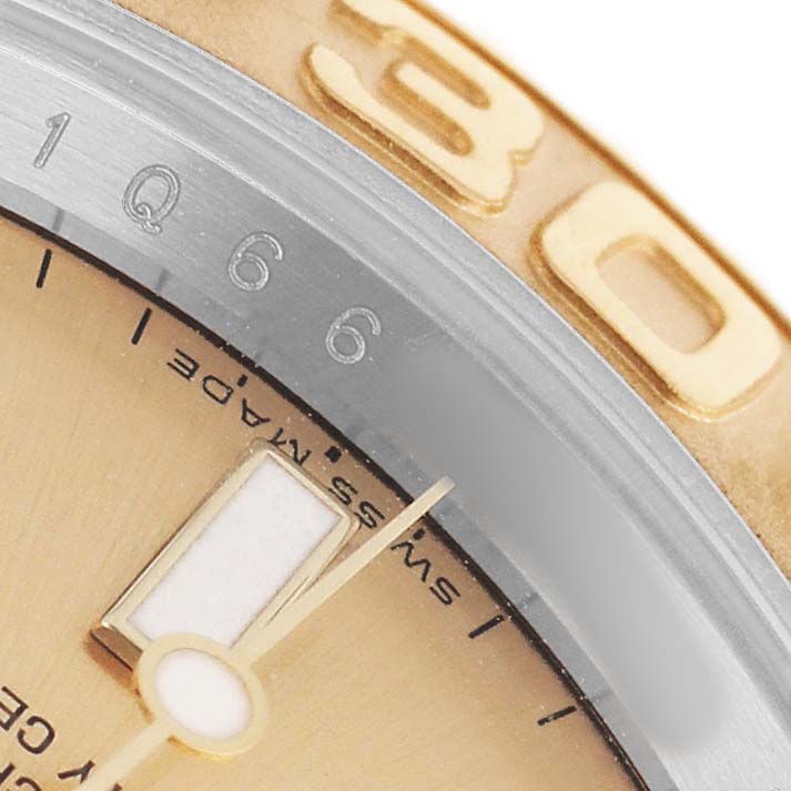 The close-up shows the bezel, part of the dial, and an hour marker of the Rolex Yacht-Master 16623 Men's Steel and Gold (two tone) Champagne Dial.