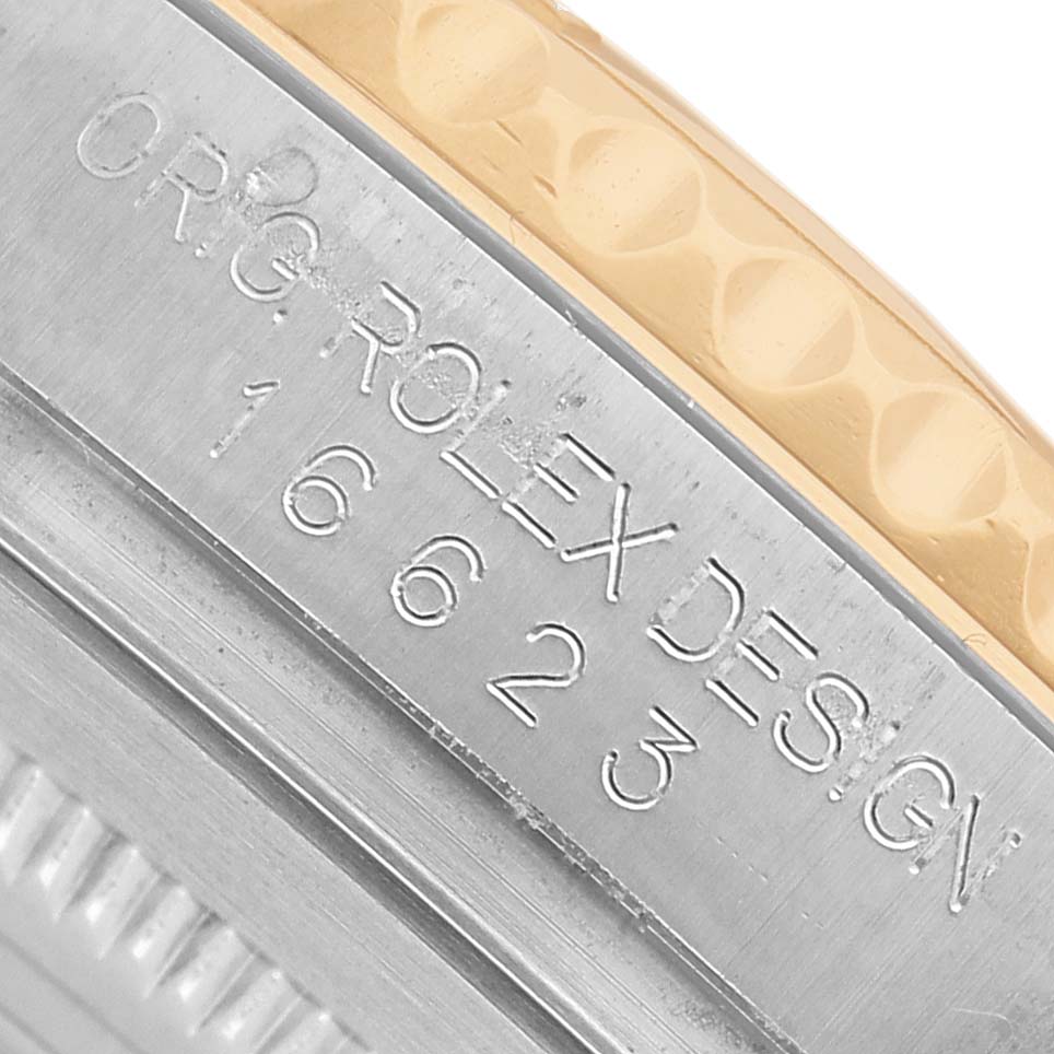 The image shows a close-up of the side of a Rolex Yacht-Master 16623 Men's Steel and Gold (two tone) Champagne Dial, highlighting the serial number and part of the bezel.