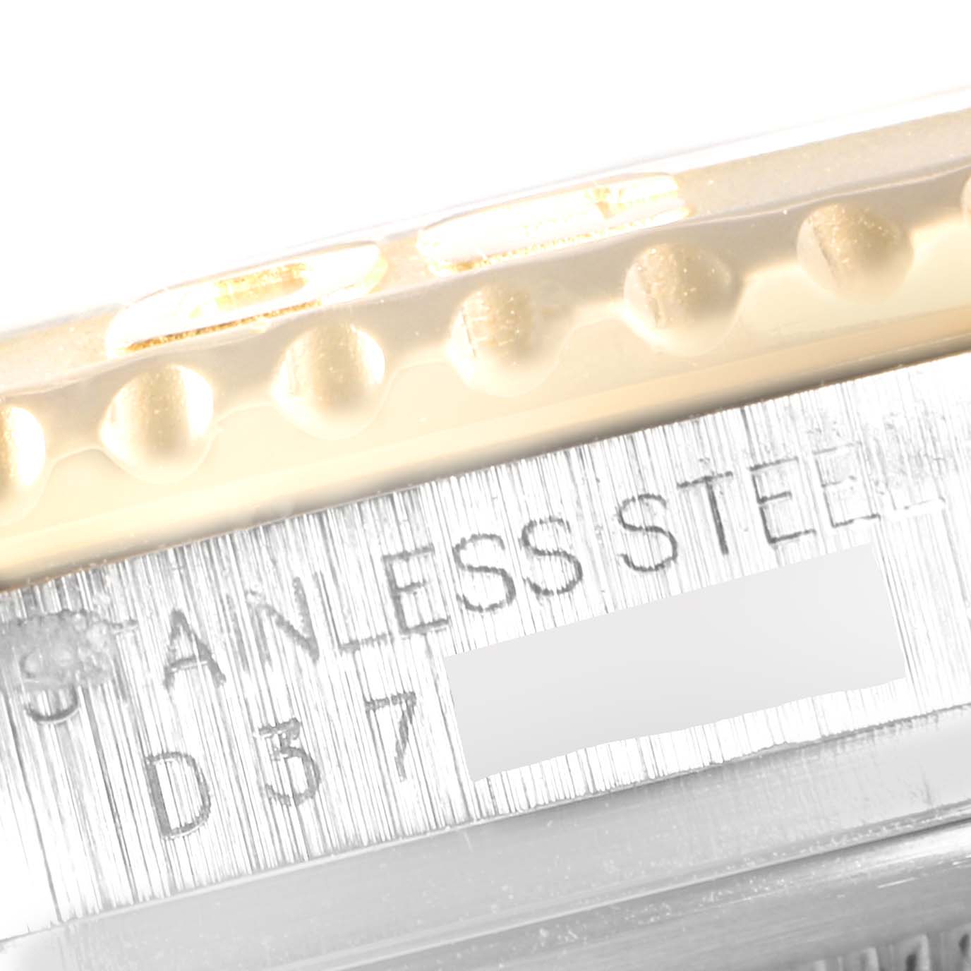 This image shows a close-up of the side of a Rolex Yacht-Master 16623 Men
s Steel and Gold (two tone) White Dial 16623 Men
s Steel and Gold (two tone) White Dial watch with "STAINLESS STEEL" engraved on it.