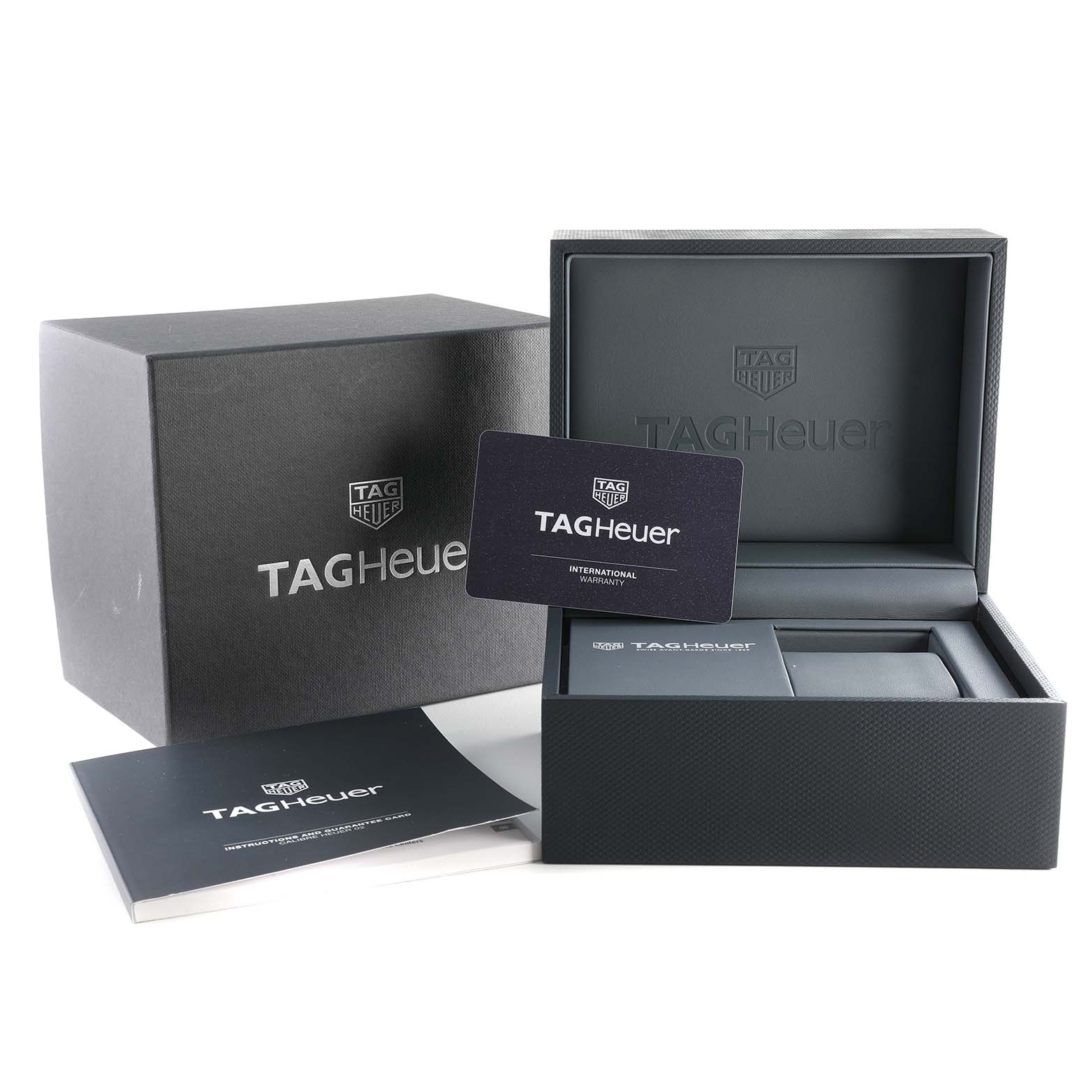 The image shows the packaging, international warranty card, and presentation box for the Tag Heuer CBN2011.BA0642 Men's Stainless Steel Blue Dial CBN2011.BA0642 Men's Stainless Steel Blue Dial Carrera Chronograph Blue Dial Steel Mens Watch CBN2011.