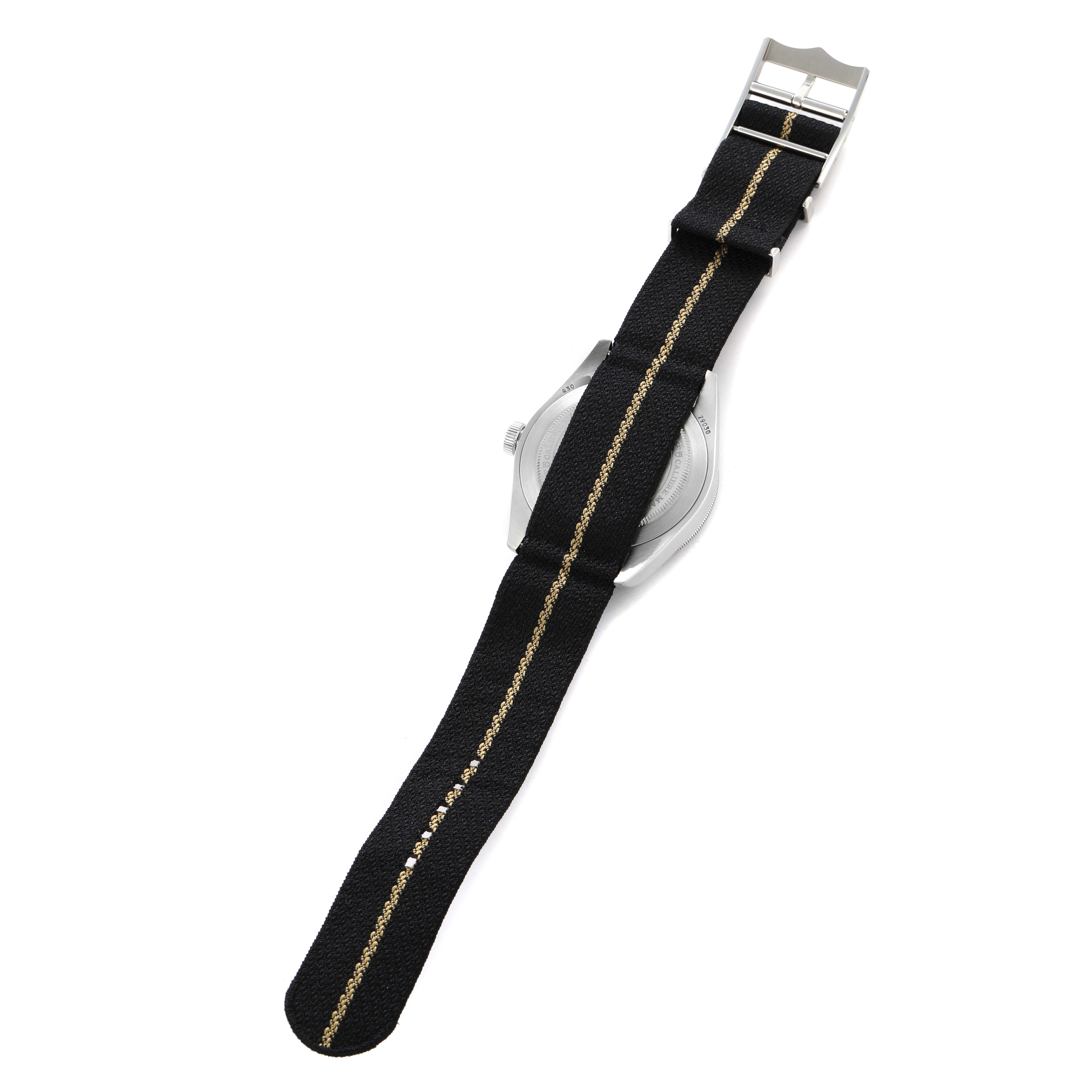 The Tudor Heritage Black Bay 79030N Men
s Stainless Steel Black Dial watch is shown from the back with a focus on its black fabric strap.