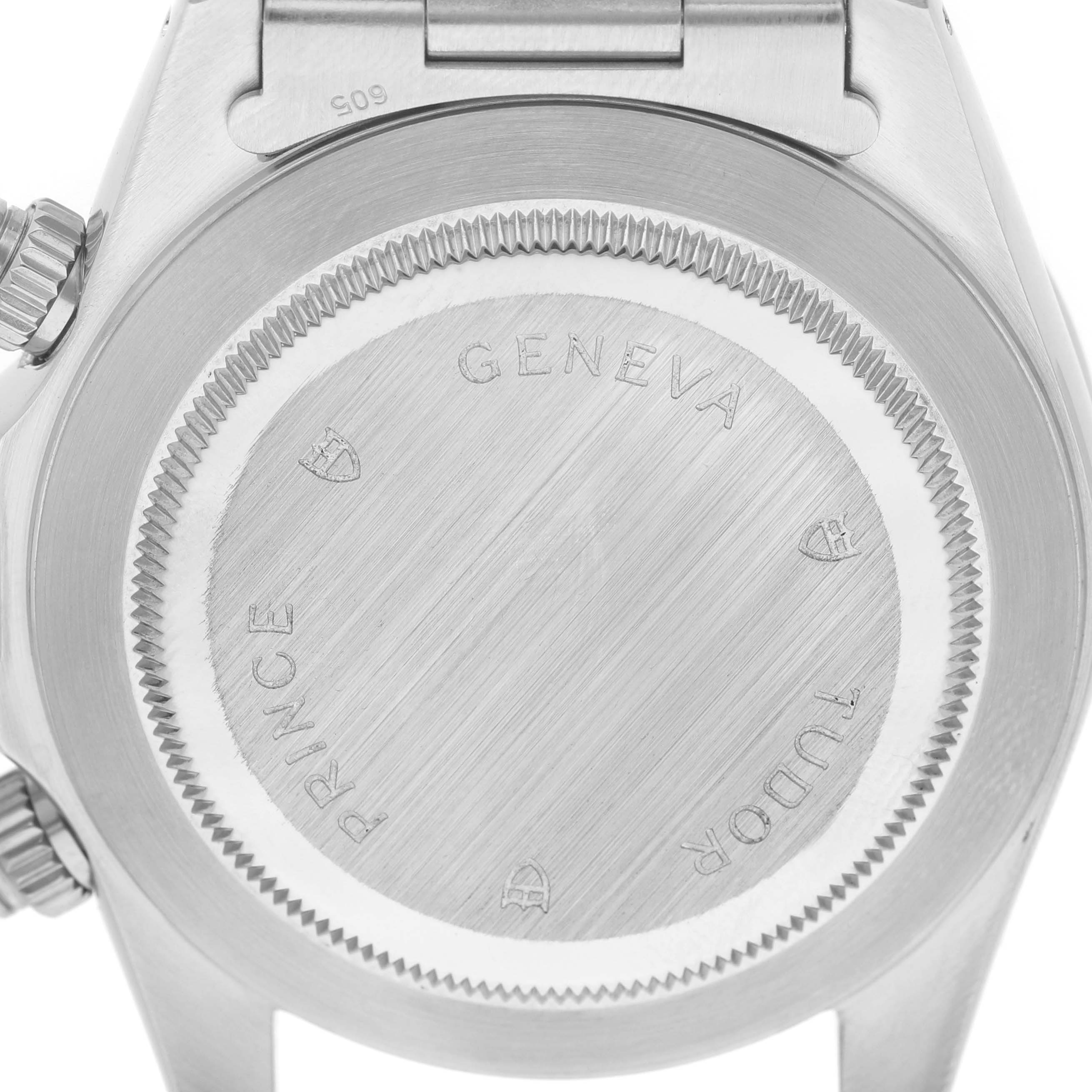 This image shows the back case of a Tudor Prince 79260 Men's Stainless Steel Silver Dial watch, featuring engravings and the edge of the bracelet attachment.