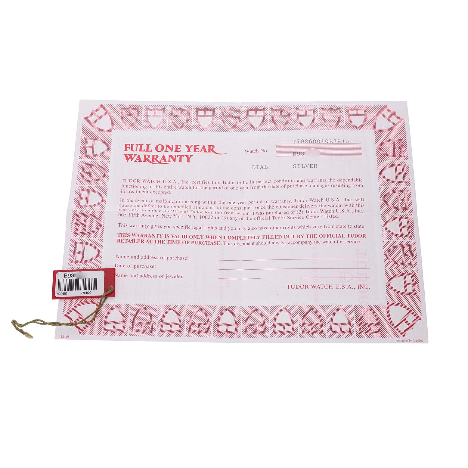 The image shows a Tudor Prince 79260 Men's Stainless Steel Silver Dial model warranty card at a top-down angle, including a red hang tag with a string.