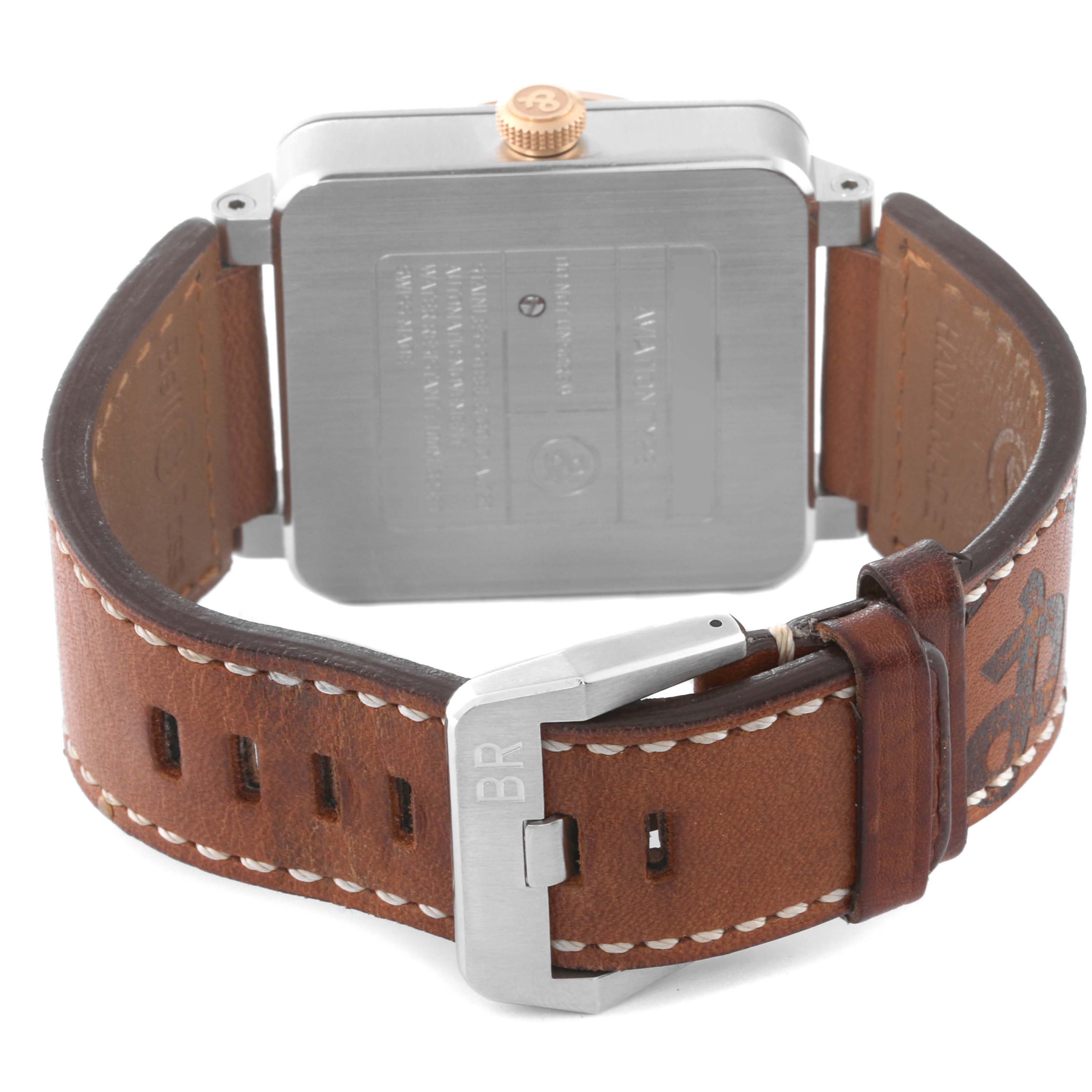 The image shows the back view of a Bell 
Ross Instruments BR03-90 Men
s Steel and Gold (two tone) Silver Dial BR03-90 Men
s Steel and Gold (two tone) Silver Dial model watch, featuring its caseback, crown, and leather strap with buckle.