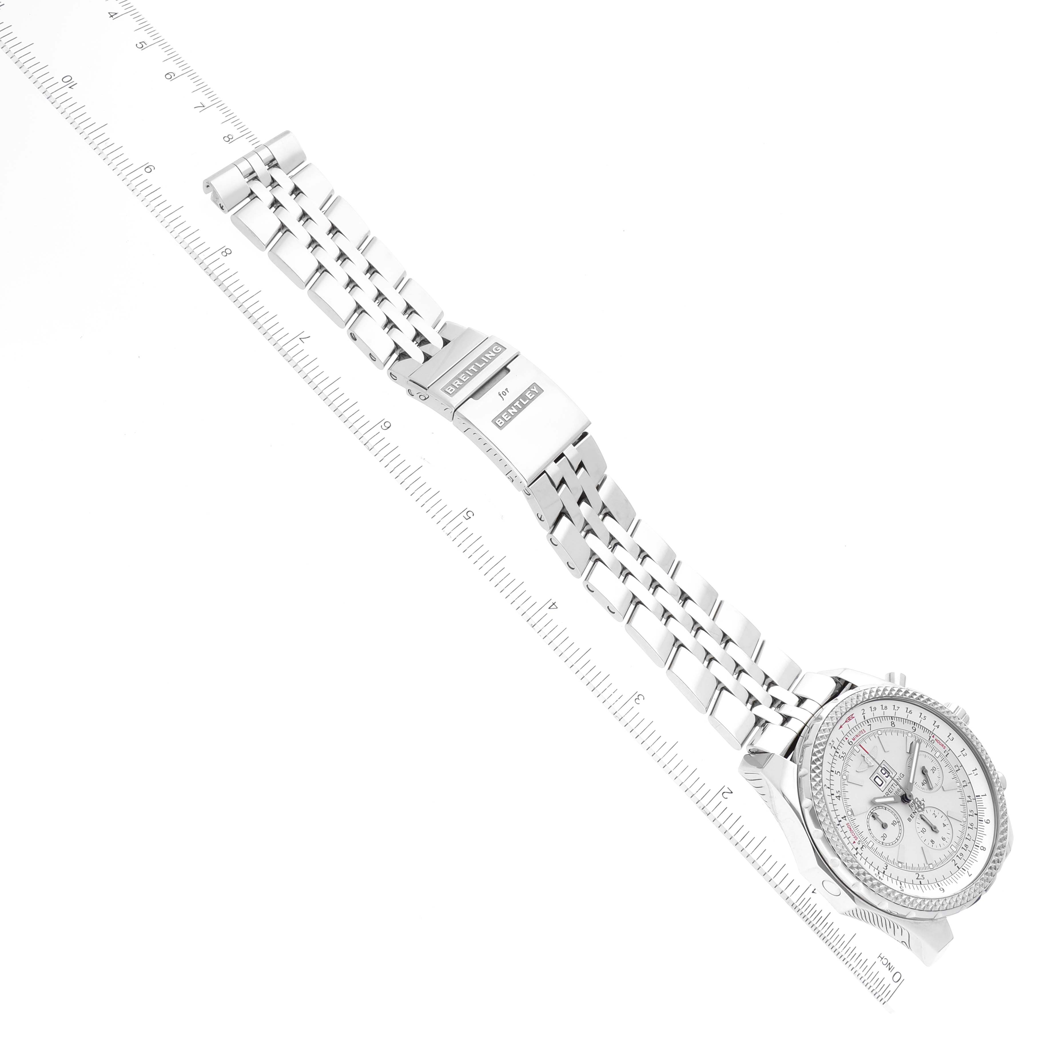 The image shows a top view of a Breitling Bentley A44362 Men's Stainless Steel Silver Dial A44362 Men's Stainless Steel Silver Dial watch, highlighting the dial, bezel, and metal bracelet with clasp laid alongside a ruler.