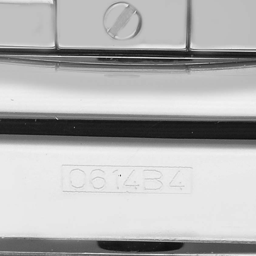 This image shows a close-up of the case back for the Breitling Chronomat AB01154G/BD13 Men's Stainless Steel Black Dial AB01154G/BD13 Men's Stainless Steel Black Dial watch, highlighting the serial number and a screw.