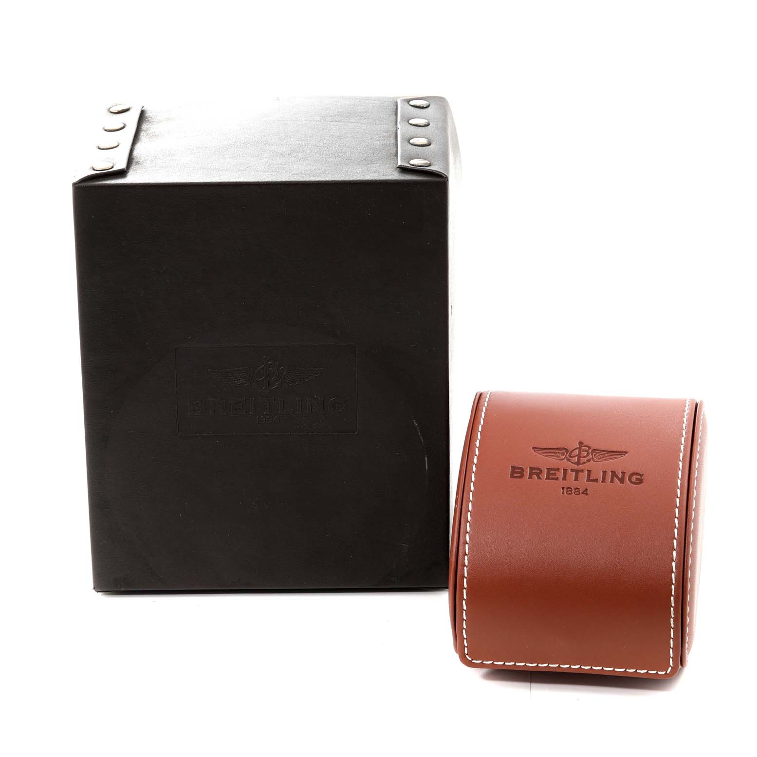 The image shows the packaging box and a leather case for the Breitling Chronomat AB041210/BB48 - 384A Men's Stainless Steel Black Dial AB041210/BB48 - 384A Men's Stainless Steel Black Dial watch, displaying the brand's logo.