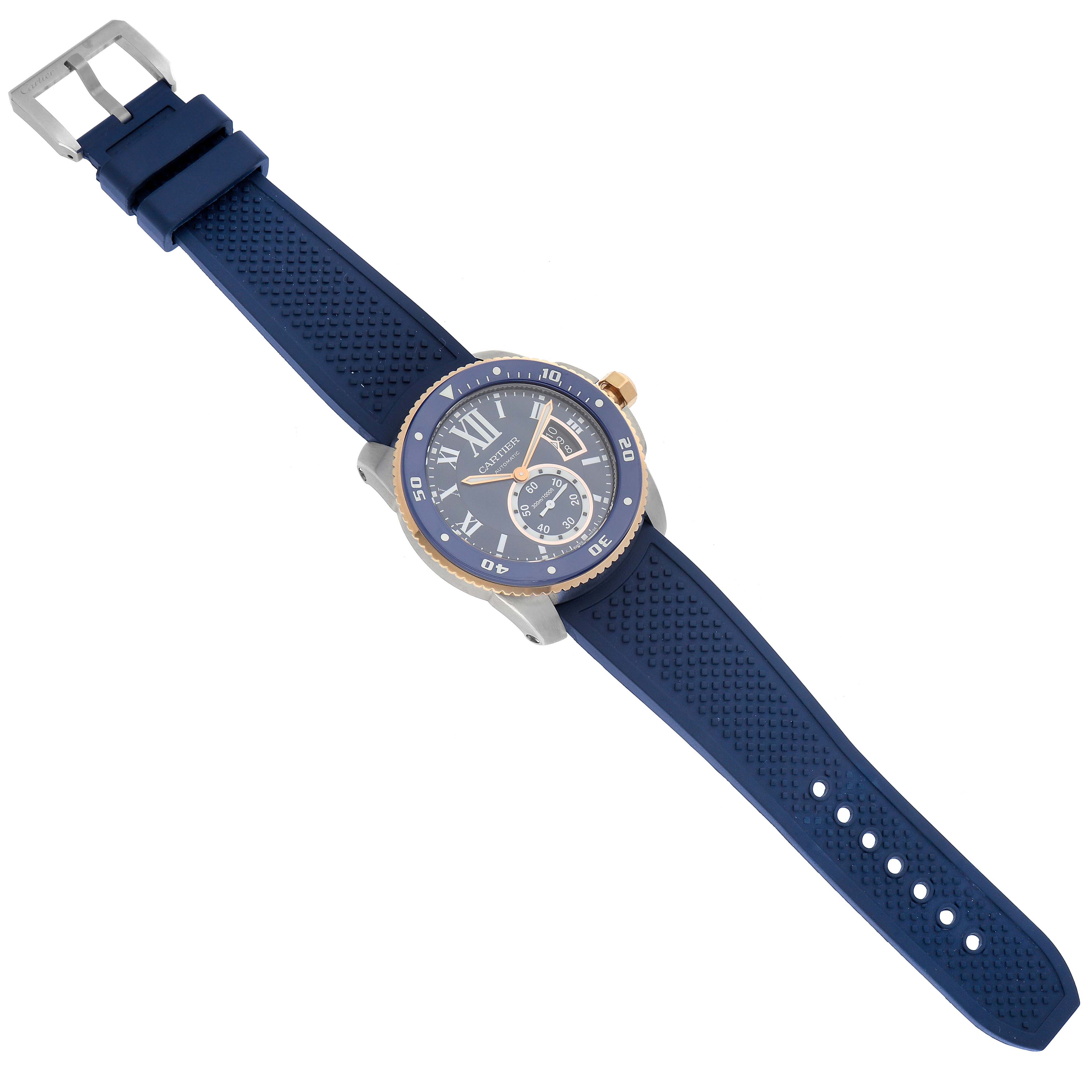 The image shows a top-down view of a Calibre de Cartier watch by Cartier with a blue strap and a blue dial.