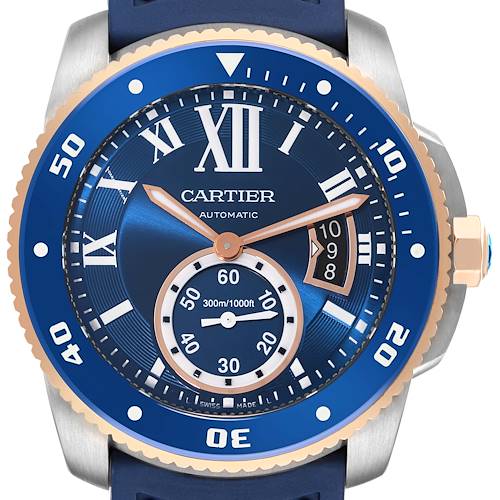 The image shows a close-up view of the Calibre de Cartier watch by Cartier, highlighting its blue dial, bezel, and hour markers.