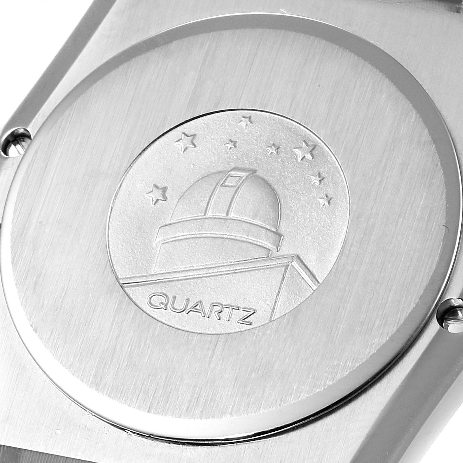 The image shows the case back of the Omega Constellation Men's Steel and Gold (two tone) Black Dial Men's Steel and Gold (two tone) Black Dial watch, featuring an observatory emblem and the word "Quartz."