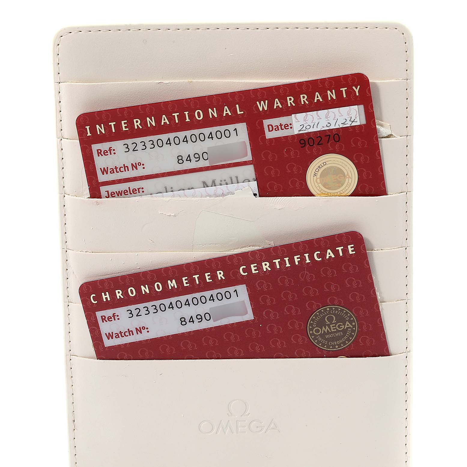 The image shows the international warranty and chronometer certificate cards for an Omega Speedmaster 323.30.40.40.04.001 Men's Stainless Steel White Dial 323.30.40.40.04.001 Men's Stainless Steel White Dial watch in a cardholder.