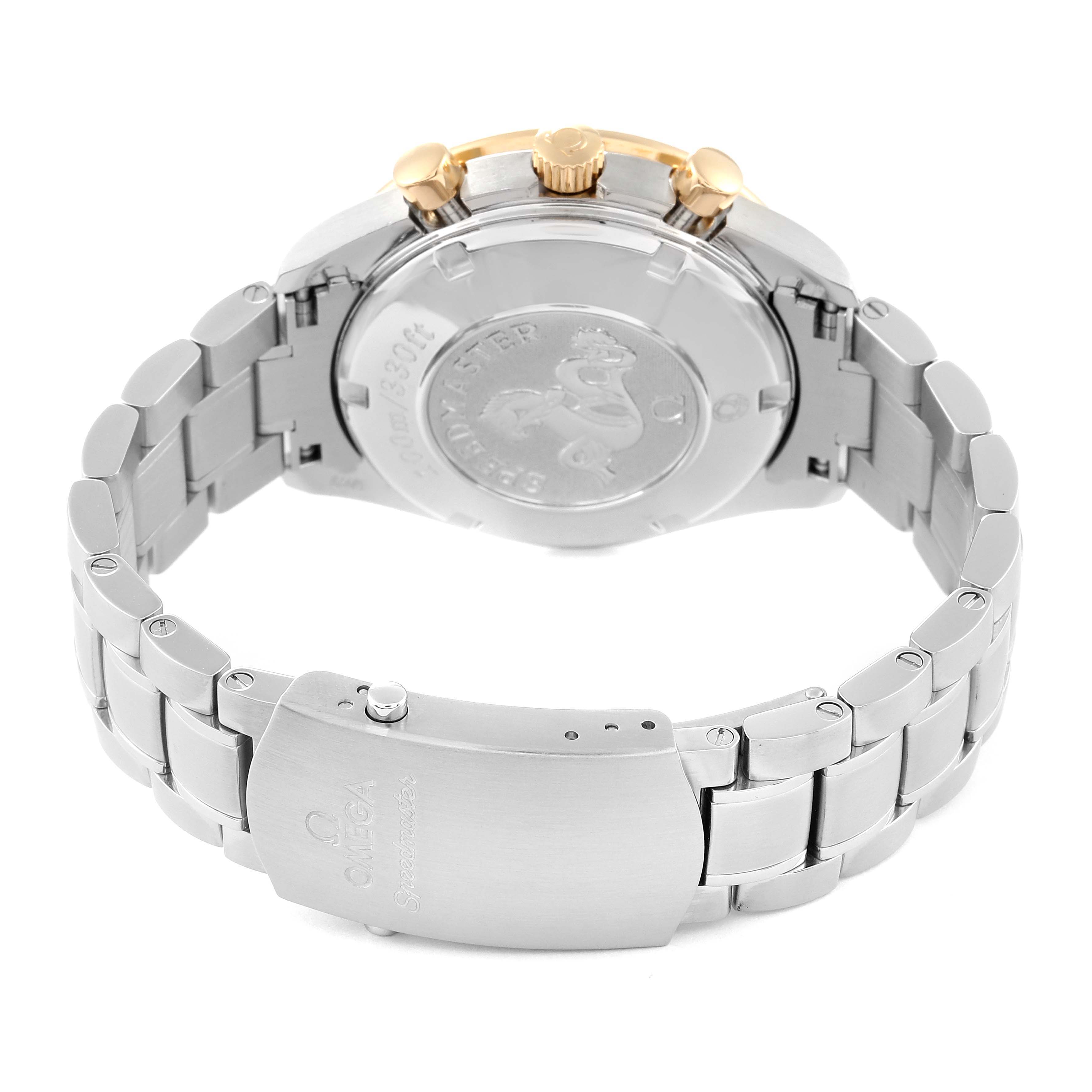 The image shows the back view of the Omega Speedmaster 323.21.40.44.02.001 Men's Steel and Gold (two tone) Silver Dial 323.21.40.44.02.001 Men's Steel and Gold (two tone) Silver Dial watch, highlighting the case back, buckle, and bracelet with gold accents on the crown.