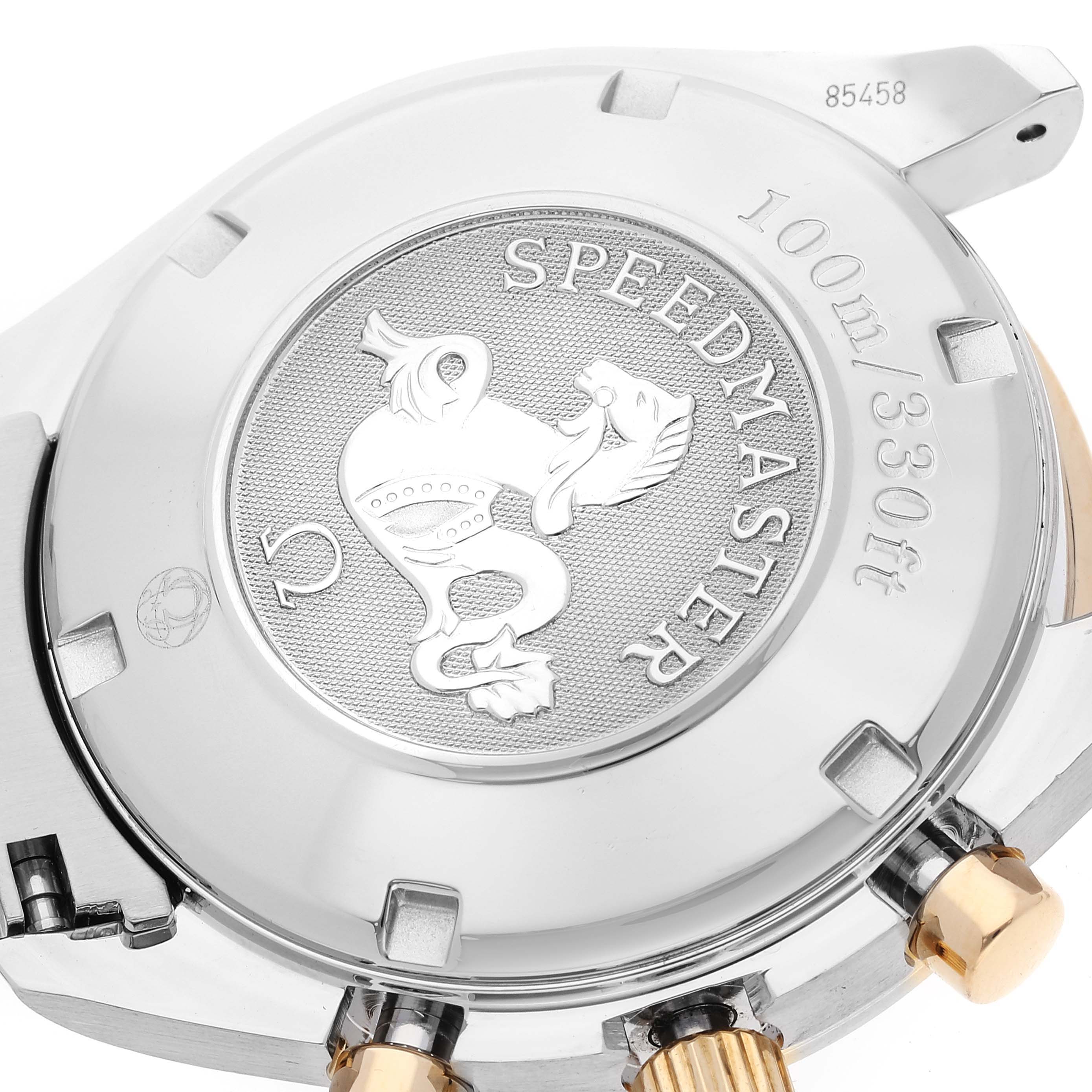 The image shows the case back of an Omega Speedmaster 323.21.40.44.02.001 Men's Steel and Gold (two tone) Silver Dial 323.21.40.44.02.001 Men's Steel and Gold (two tone) Silver Dial watch, displaying its emblem and water resistance.