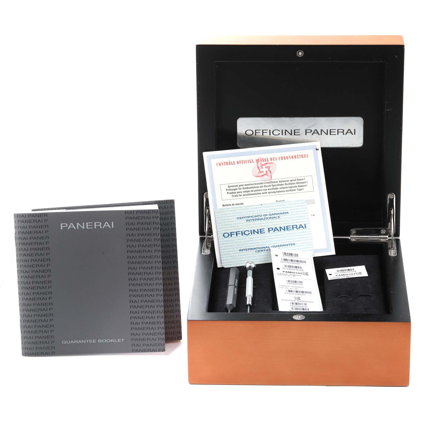 This image shows the packaging and accessories for a Panerai Luminor PAM00104 Men
s Stainless Steel Black Dial PAM00104 Men
s Stainless Steel Black Dial watch, including the guarantee booklet, certificates, and tools.
