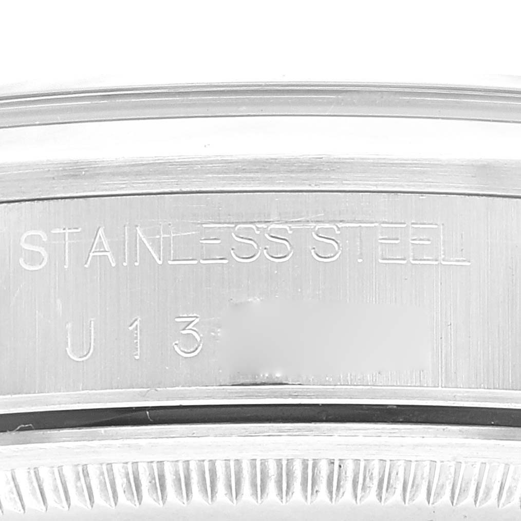 This image shows a close-up of the case back edge of a Rolex Air-King 14000 Men's Stainless Steel Blue Dial 14000 Men's Stainless Steel Blue Dial watch, highlighting the stainless steel marking and serial number.