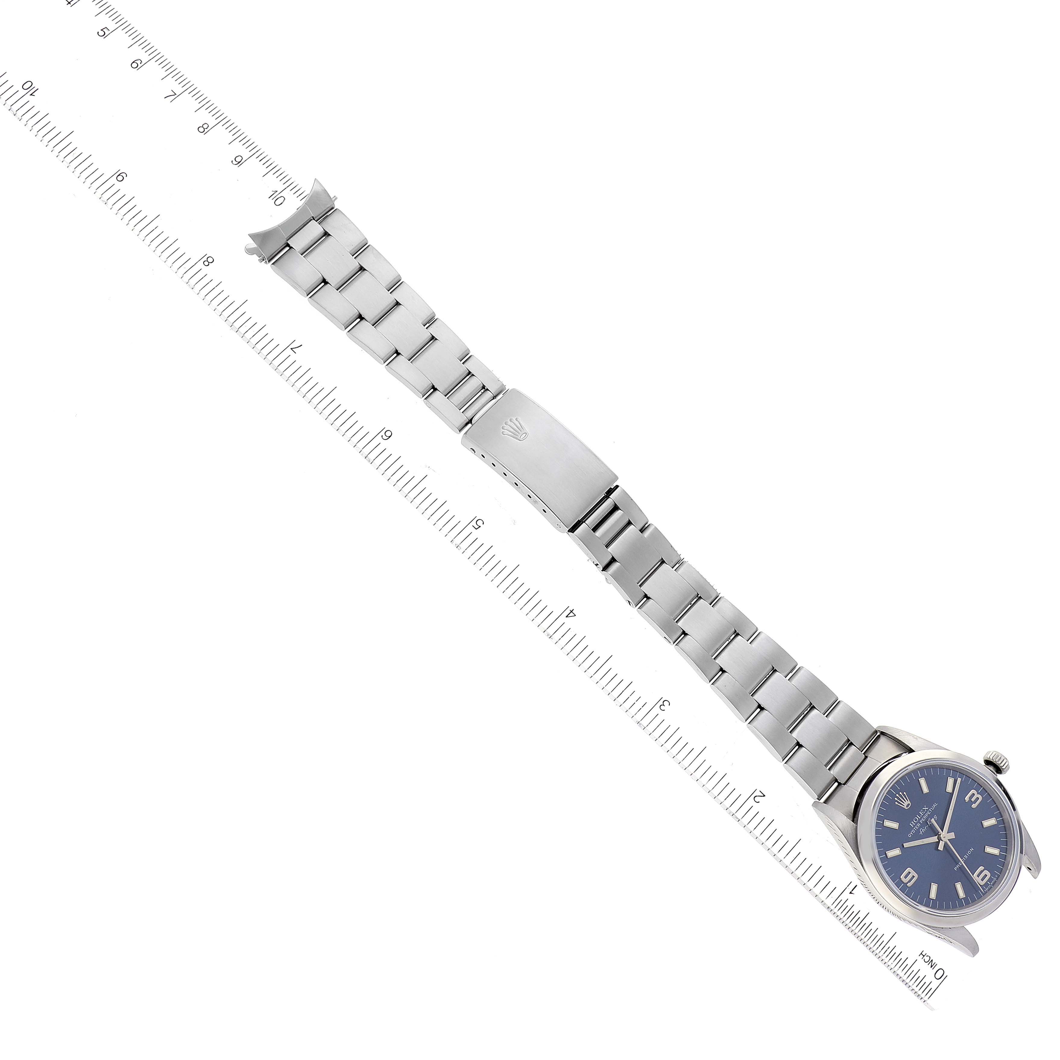The Rolex Air-King 14000 Men's Stainless Steel Blue Dial 14000 Men's Stainless Steel Blue Dial watch is shown flat with the full bracelet and clasp visible, accompanied by a ruler for scale.