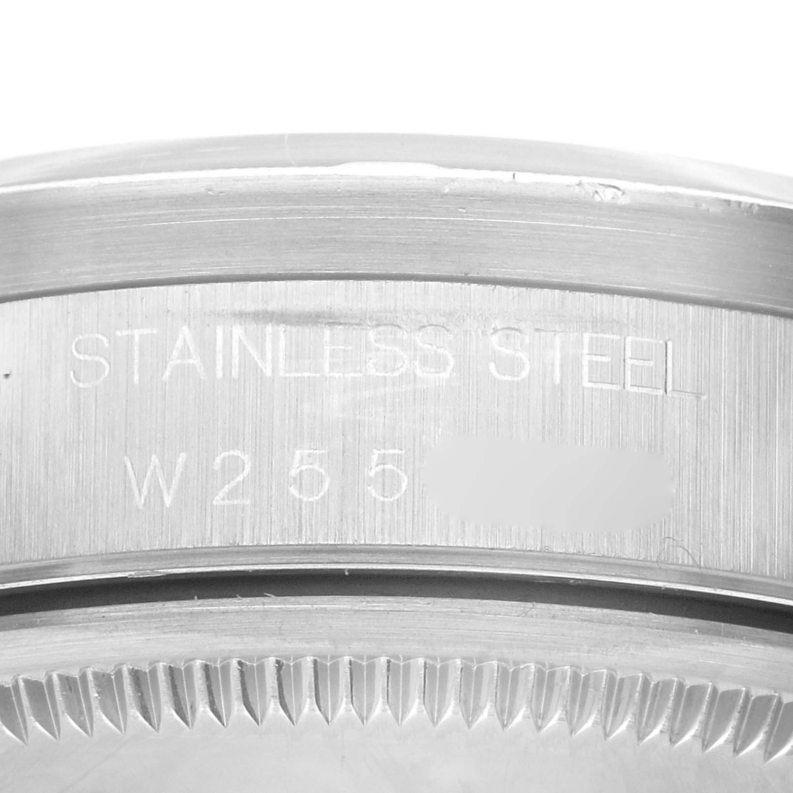 The image shows a close-up of the caseback edge of the Rolex Air-King 14010 Men's Stainless Steel Blue Dial 14010 Men's Stainless Steel Blue Dial watch with serial and model number engraving.