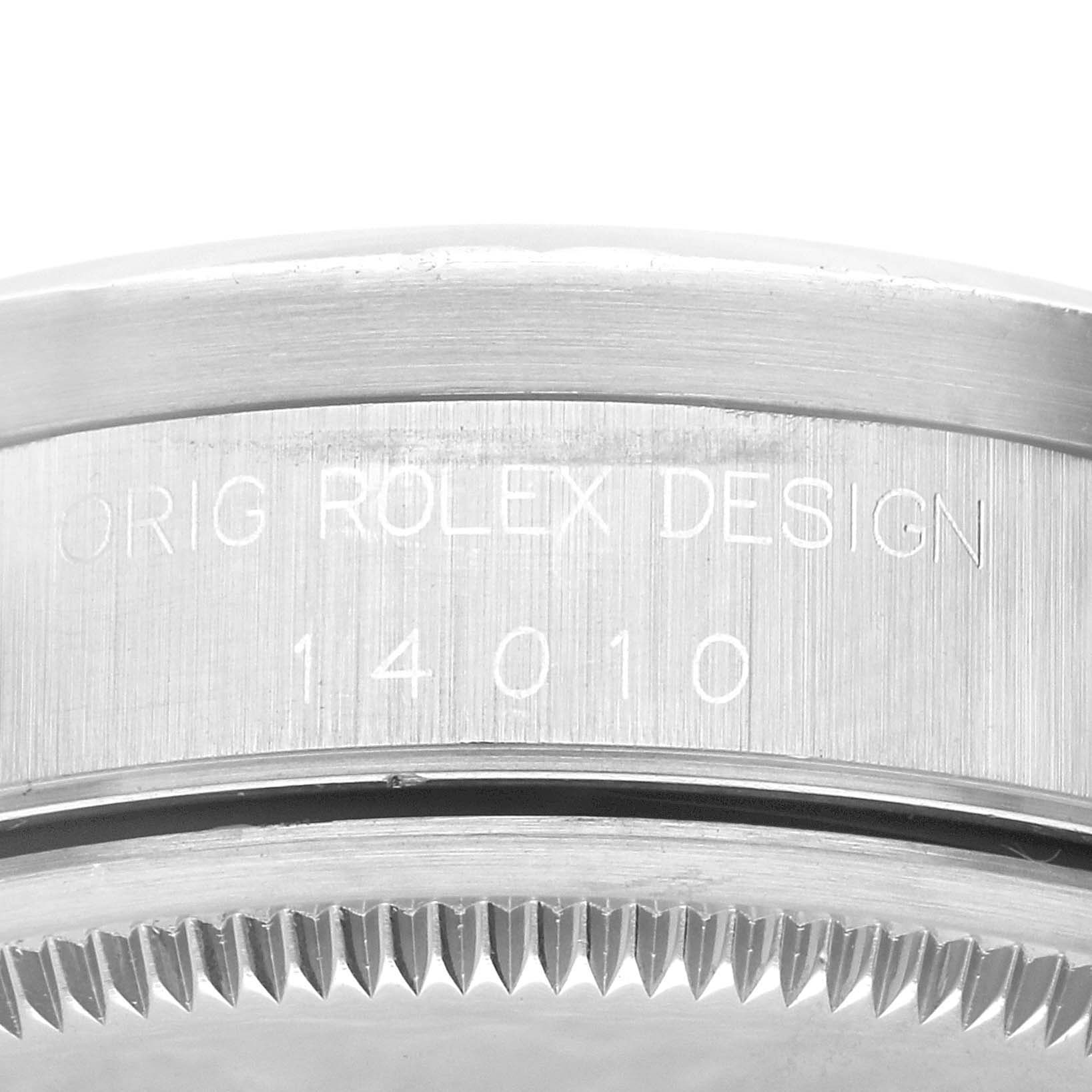 This image shows a close-up of the side of a Rolex Air-King 14010 Men's Stainless Steel Blue Dial 14010 Men's Stainless Steel Blue Dial watch, displaying the "ORIG ROLEX DESIGN 14010" engraving.